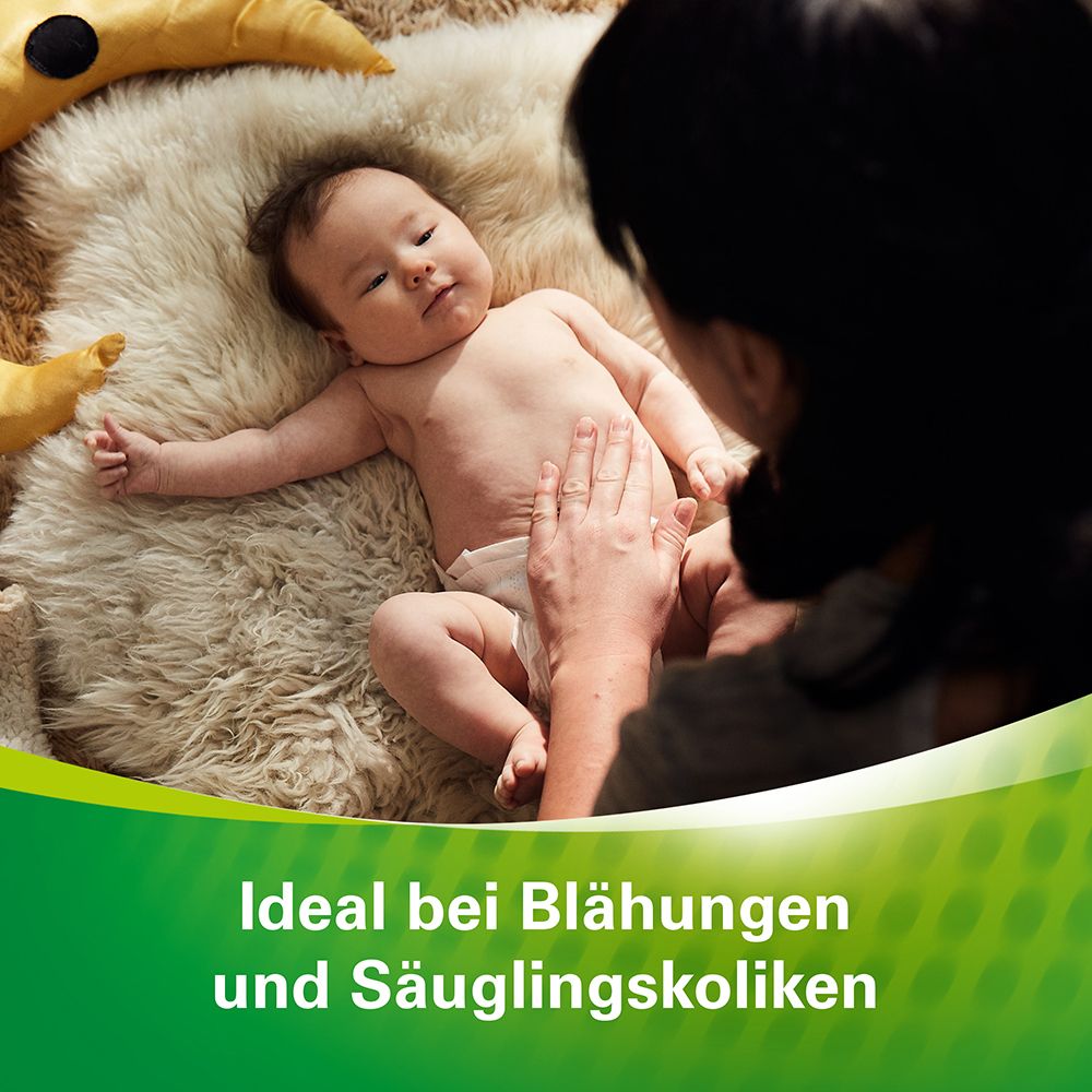 Baby auf Fell, Mutter berührt Bauch. Text: Ideal bei Blähungen und Säuglingskoliken.