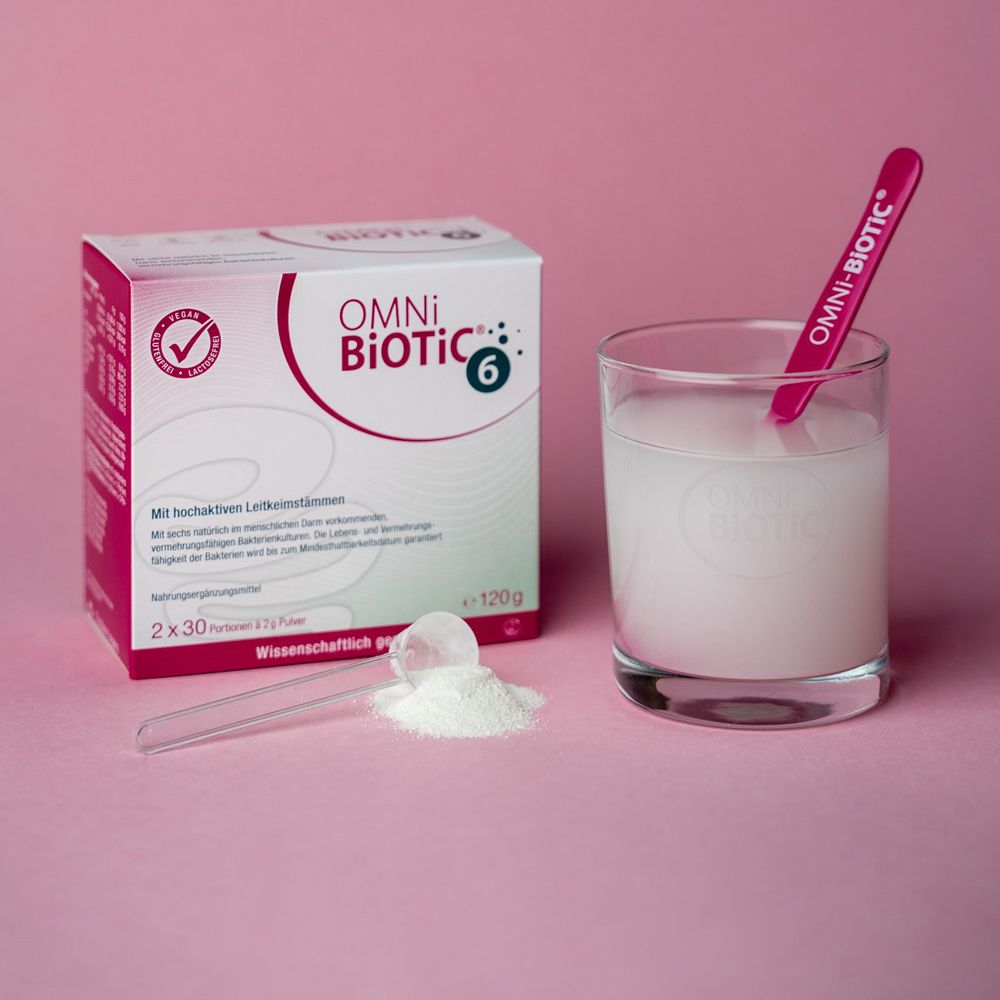 OMNi BiOTiC® 6 Packung, Glas mit aufgelöstem Pulver und Messlöffel mit Produkt.
