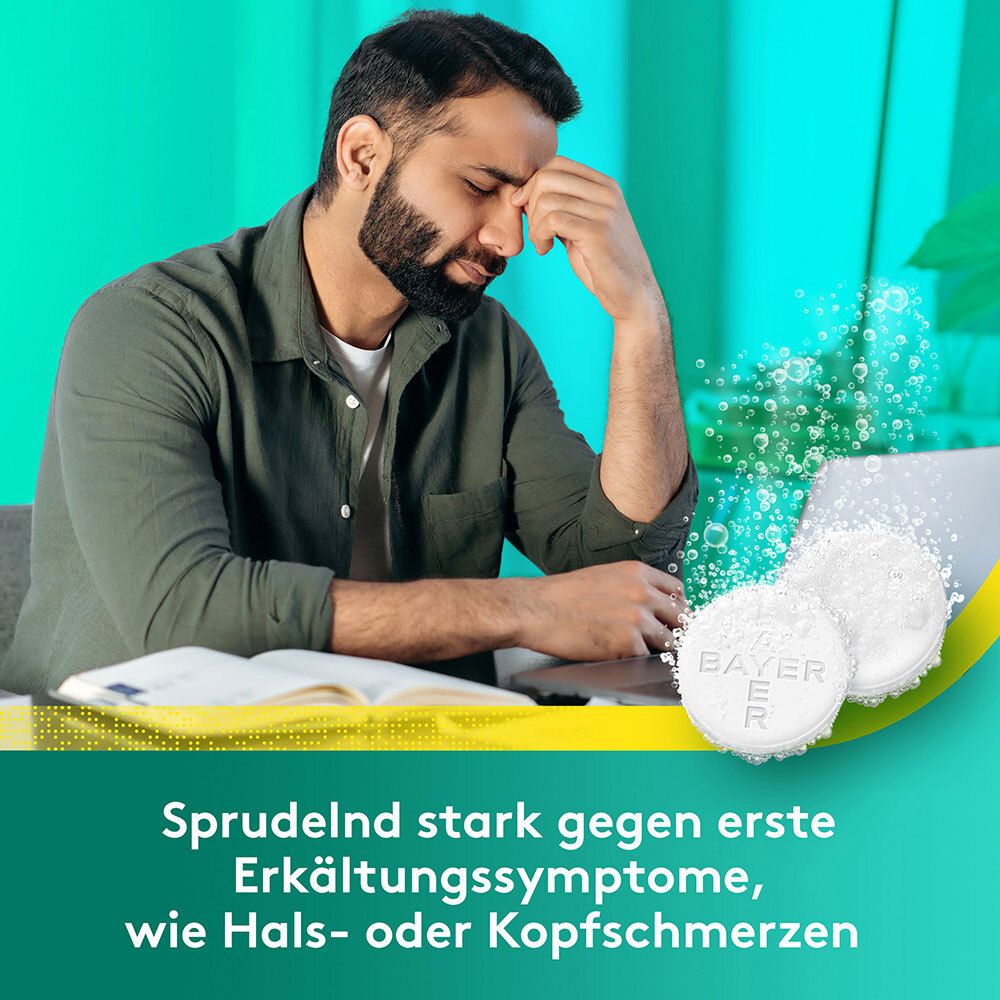 Mann mit Kopfschmerzen. Aspirin + C Brausetabletten und Text: Sprudelnd stark gegen erste Erkältungssymptome.
