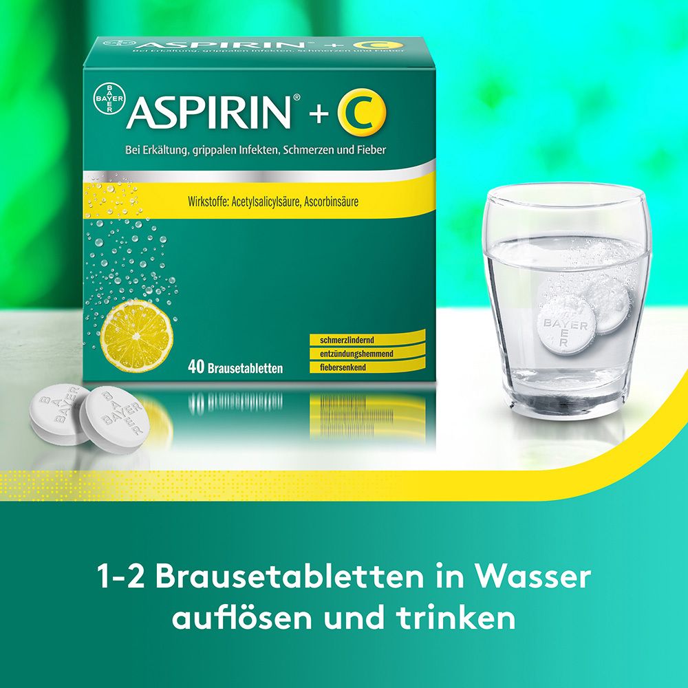 Aspirin + C Brausetabletten-Packung und zwei Tabletten in einem Glas Wasser. Text.