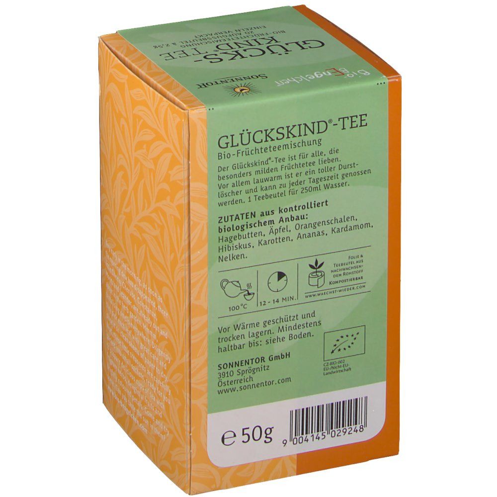 Karton mit Aufdrucken. Aufschrift: Glückskind Tee. Zutatenliste. Bio-Siegel. Orangefarbener Hintergrund mit Blättern. 50g.