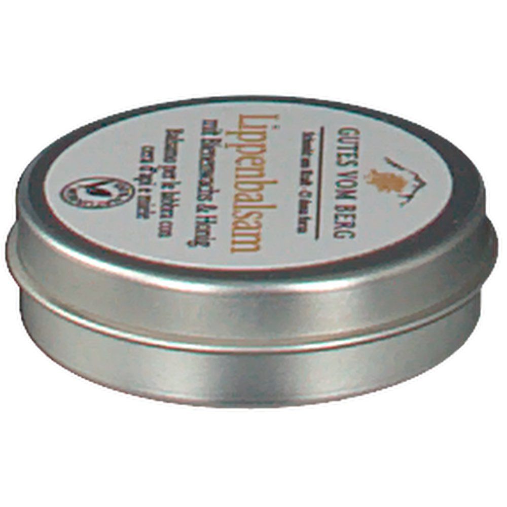 Runde Metallbox mit Deckel. Aufschrift: GUTES VOM BERG Lippenbalsam mit Bienenwachs & Honig. Siegel.