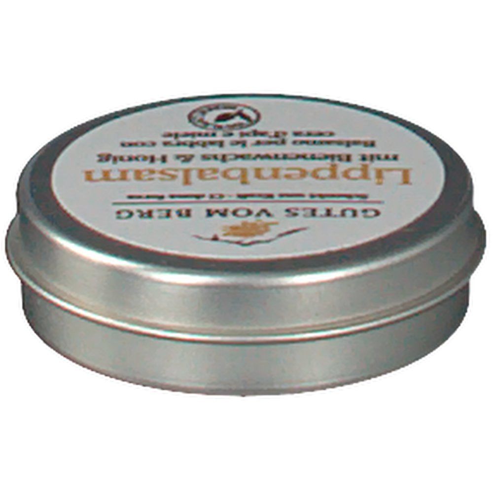 Runde Metallbox mit Deckel. Aufschrift: GUTES VOM BERG Lippenbalsam mit Bienenwachs & Honig. Siegel.