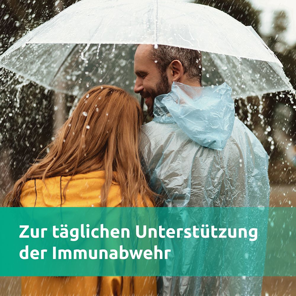 Paar unter Regenschirm im Regen. Text: Zur täglichen Unterstützung der Immunabwehr.