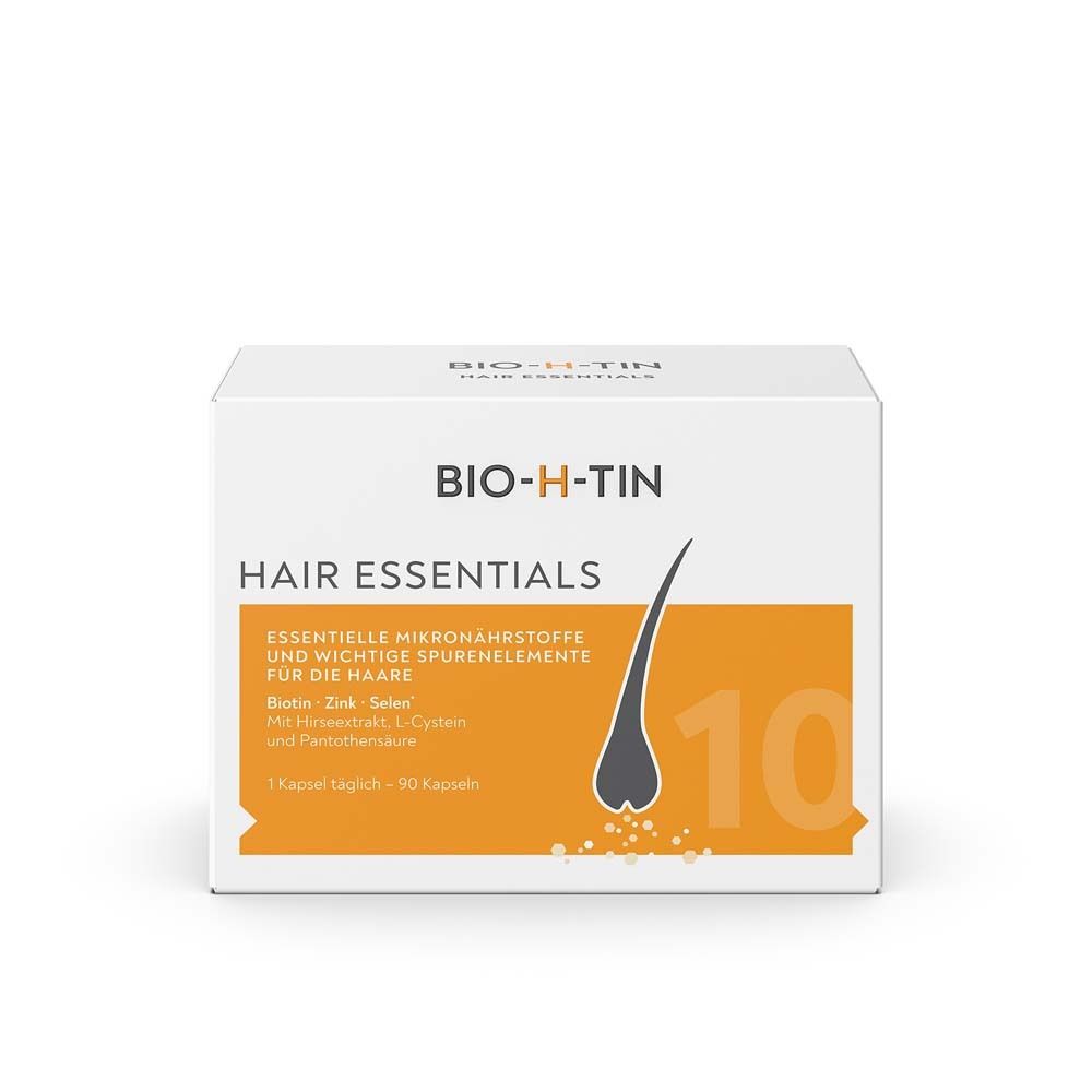Weißer Karton mit BIO-H-TIN Hair Essentials. Orangefarbener Bereich mit Haarsymbol. Text: Essentielle Mikronährstoffe und wichtige Spurenelemente.
