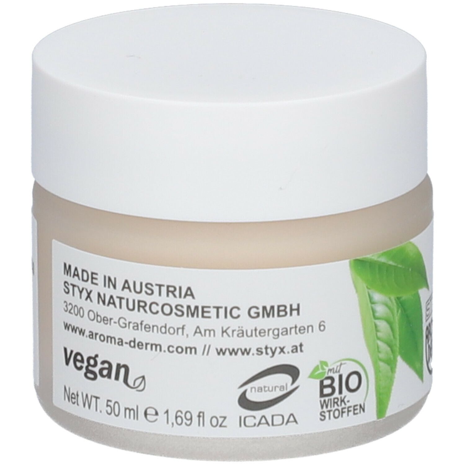 Creme-Tiegel mit weißem Deckel. Aufkleber mit grünen Blättern, Logo, Text 'vegan' und 'BIO Wirk-Stoffen'.