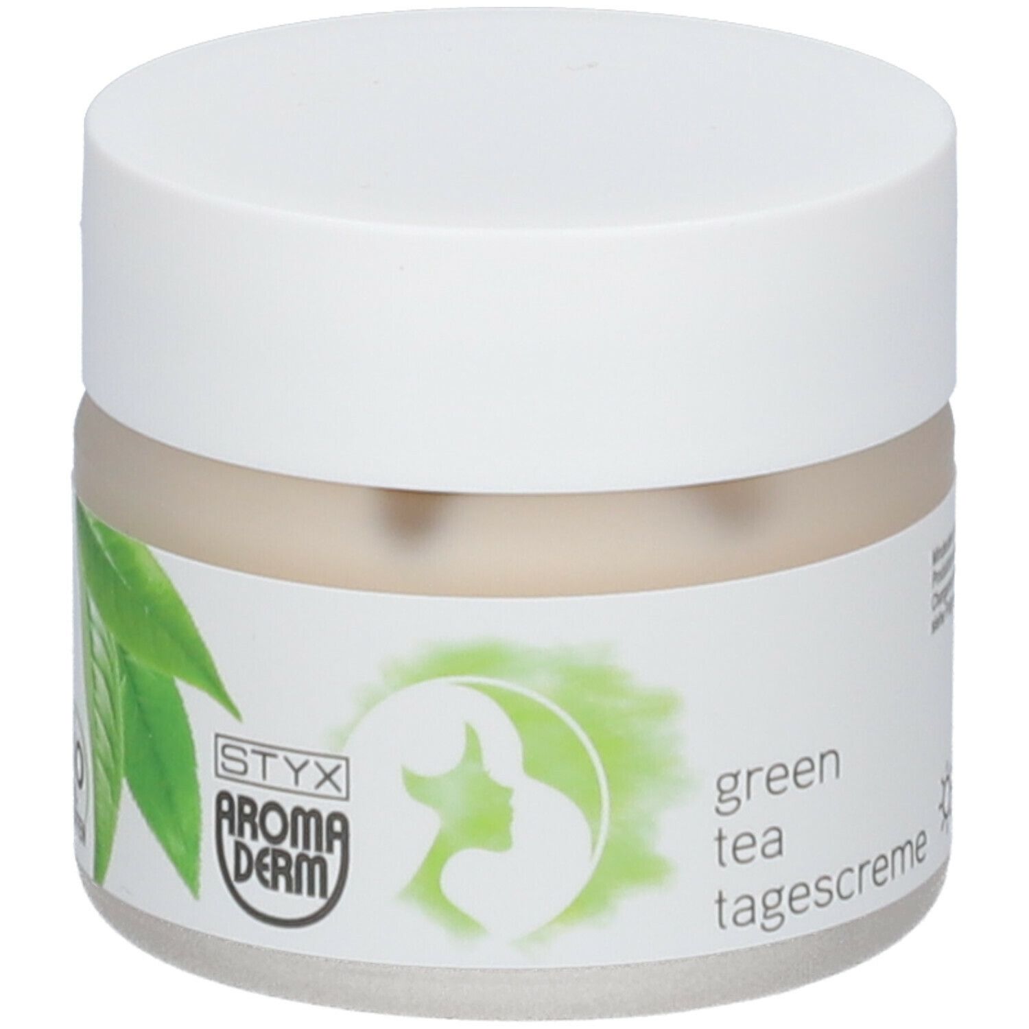 Creme-Tiegel mit weißem Deckel. Aufkleber mit grünen Blättern, Logo und Text 'green tea tagescreme'.