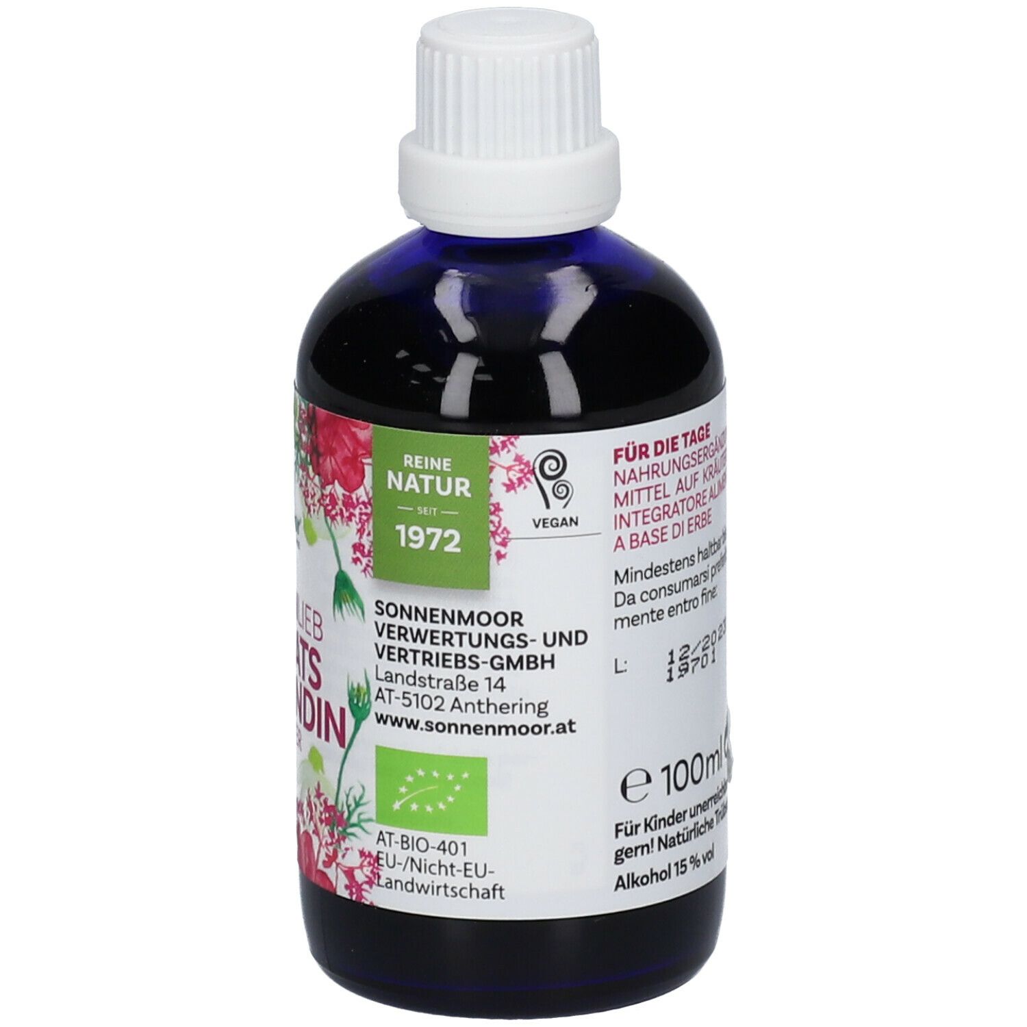 Braune Glasflasche mit blauem Inhalt, weißem Deckel. Etikett mit Produktnamen, Logo, floralen Elementen, Qualitätssiegel und Vegan-Zeichen.