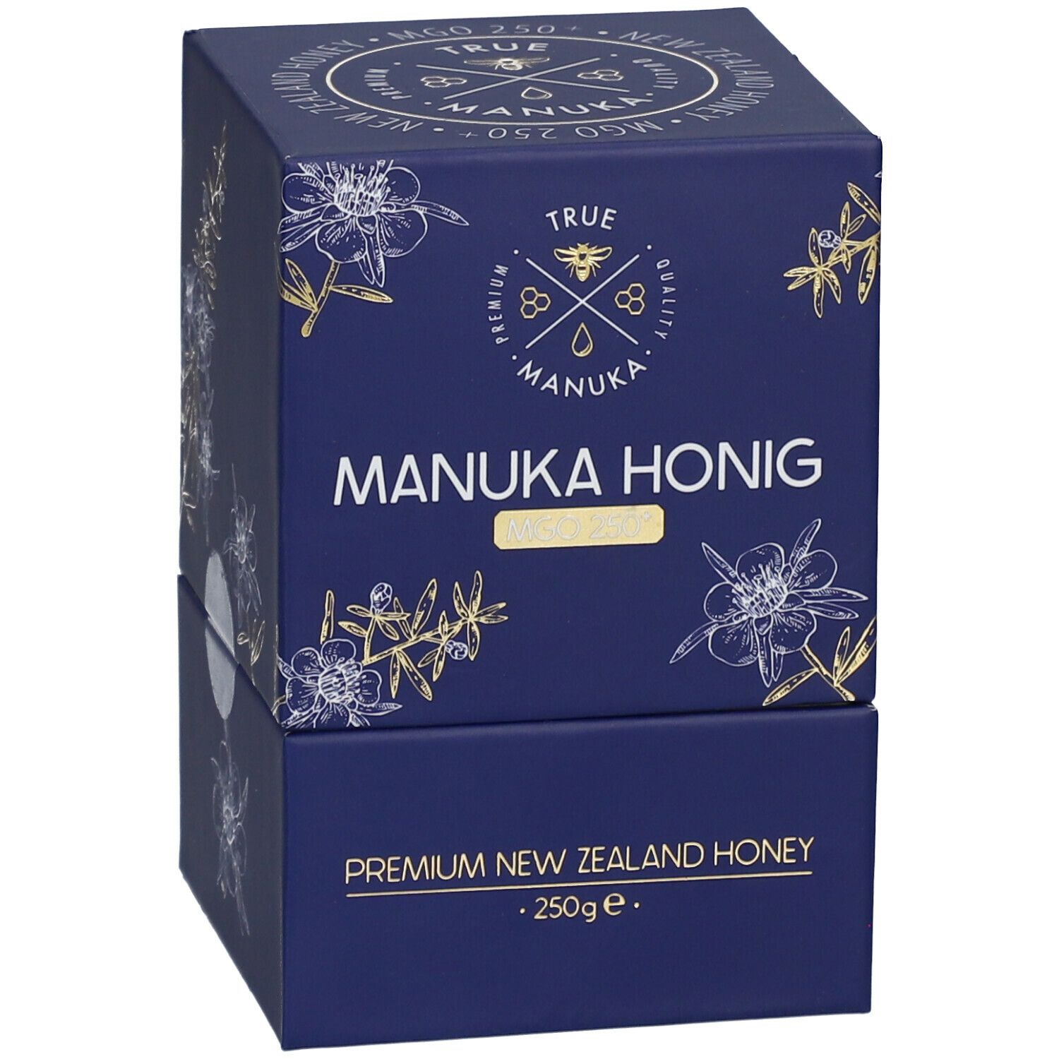 Dunkelblaue Schachtel mit weiß-goldenen floralen Motiven. Aufschrift: "TRUE MANUKA MANUKA HONIG MGO 250+". "Premium New Zealand Honey".