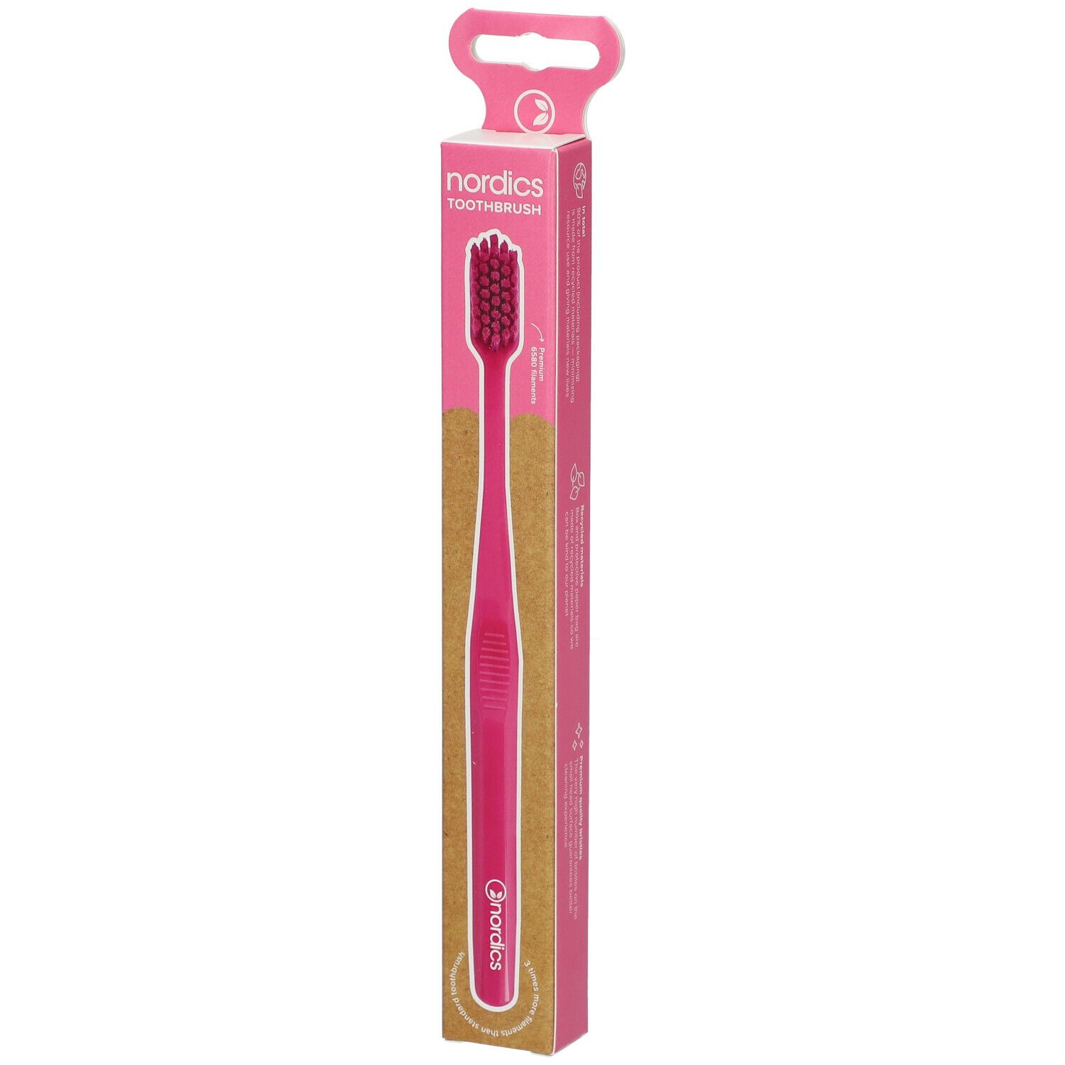 Rosa Zahnbürste in Verpackung. Aufdruck: nordics TOOTHBRUSH. Griff und Borsten rosa. Verpackung mit Aufhänger.