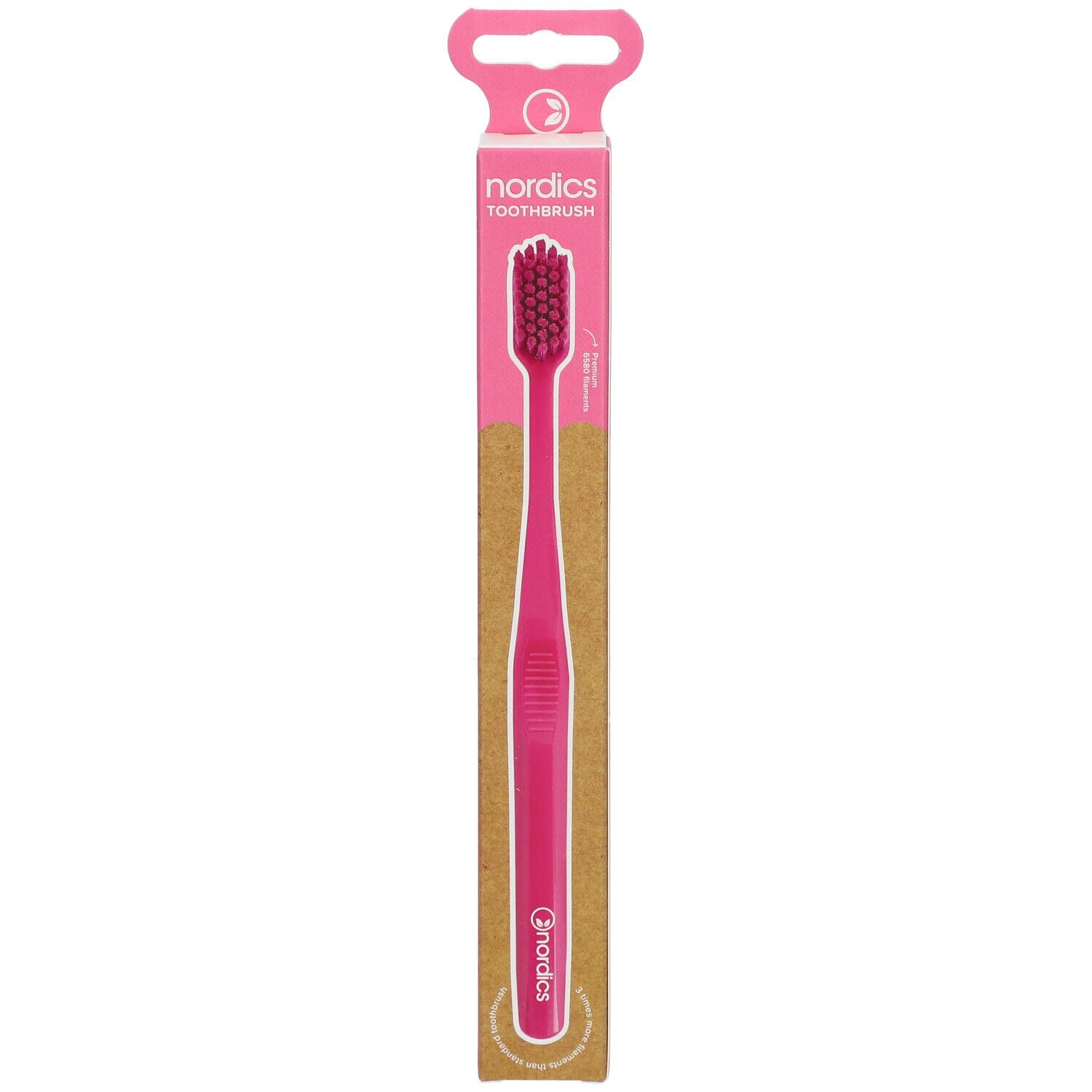 Rosa Zahnbürste in Verpackung. Aufdruck: nordics TOOTHBRUSH. Griff und Borsten rosa. Verpackung mit Aufhänger.