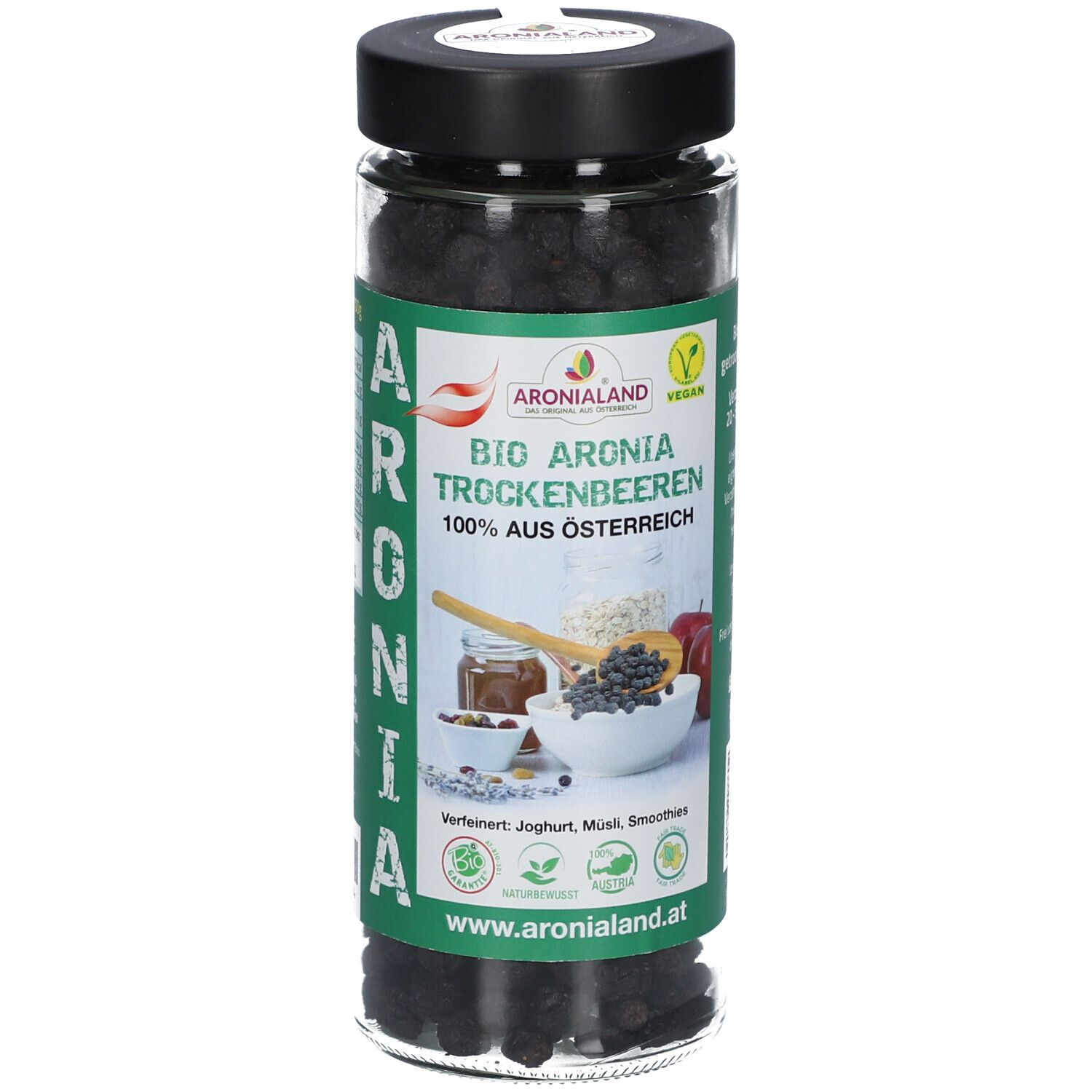 Glas mit getrockneten Aronia-Beeren. Grün-weißes Etikett mit Produktname, Logo und Illustrationen. Schwarzer Deckel.