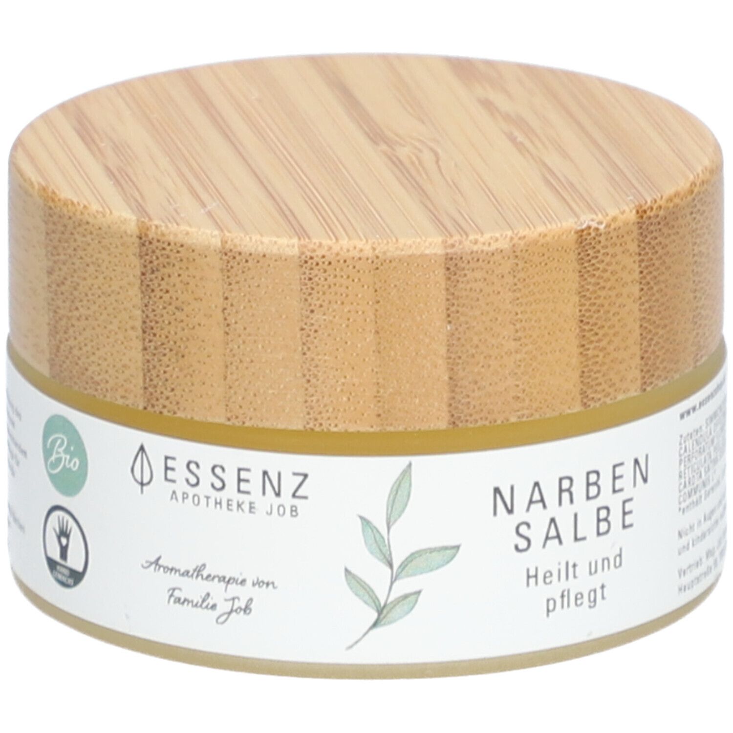 Runde Dose mit Holzdeckel. Aufkleber mit "Essenz Narbensalbe". Bio-Siegel und Hand-Symbol.