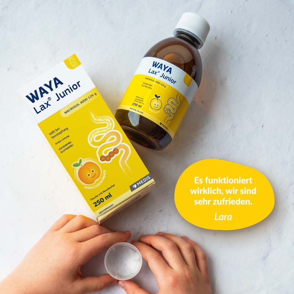 WAYA Lax® Junior Flasche und Verpackung. Mit Messbecher. Text: Es funktioniert wirklich, wir sind sehr zufrieden.