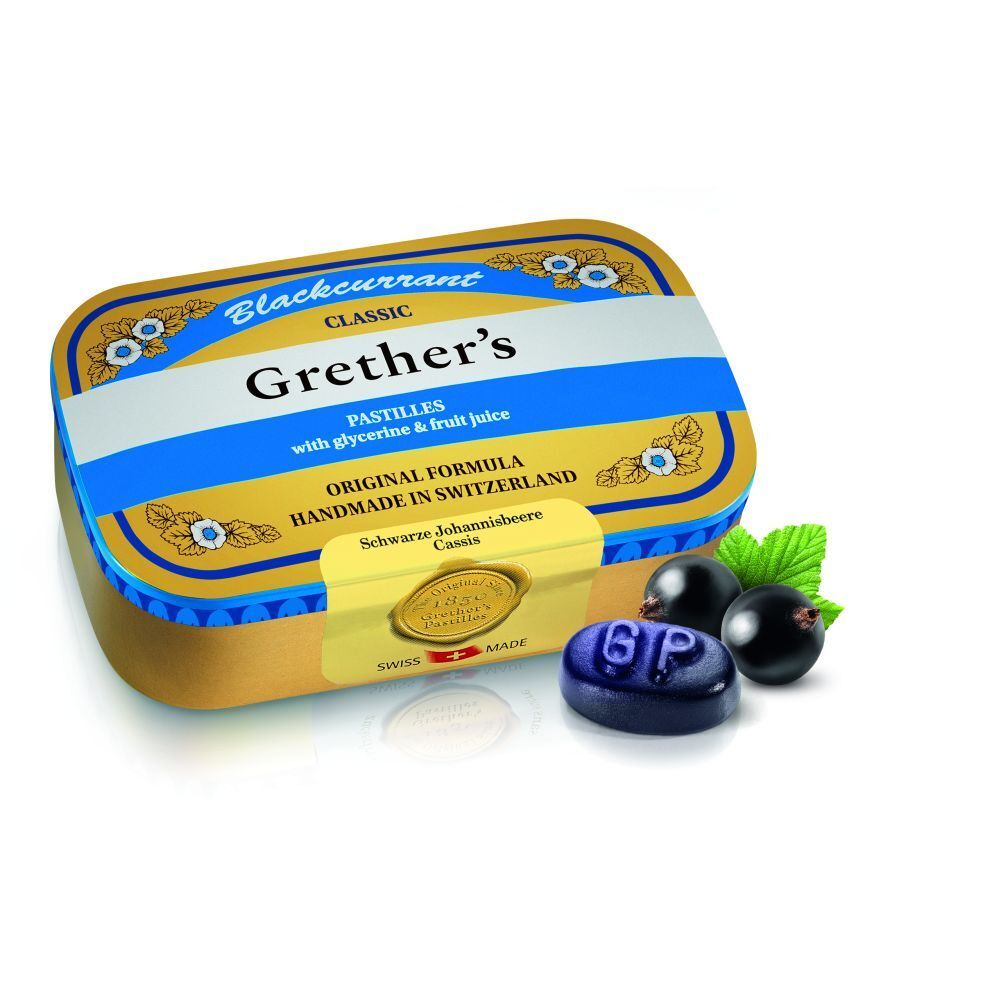 Boîte dorée avec couvercle bleu. Grether's Pastilles Blackcurrant, pastilles et cassis. Fabriqué en Suisse.