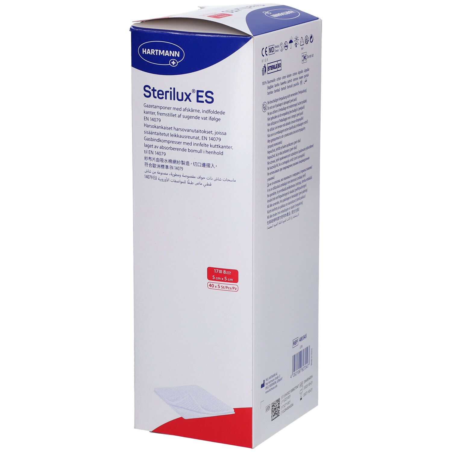 Verpakking van Sterilux ES kompressen. Witte doos met blauwe en rode tekst. Hartmann-logo. Meertalige tekst.