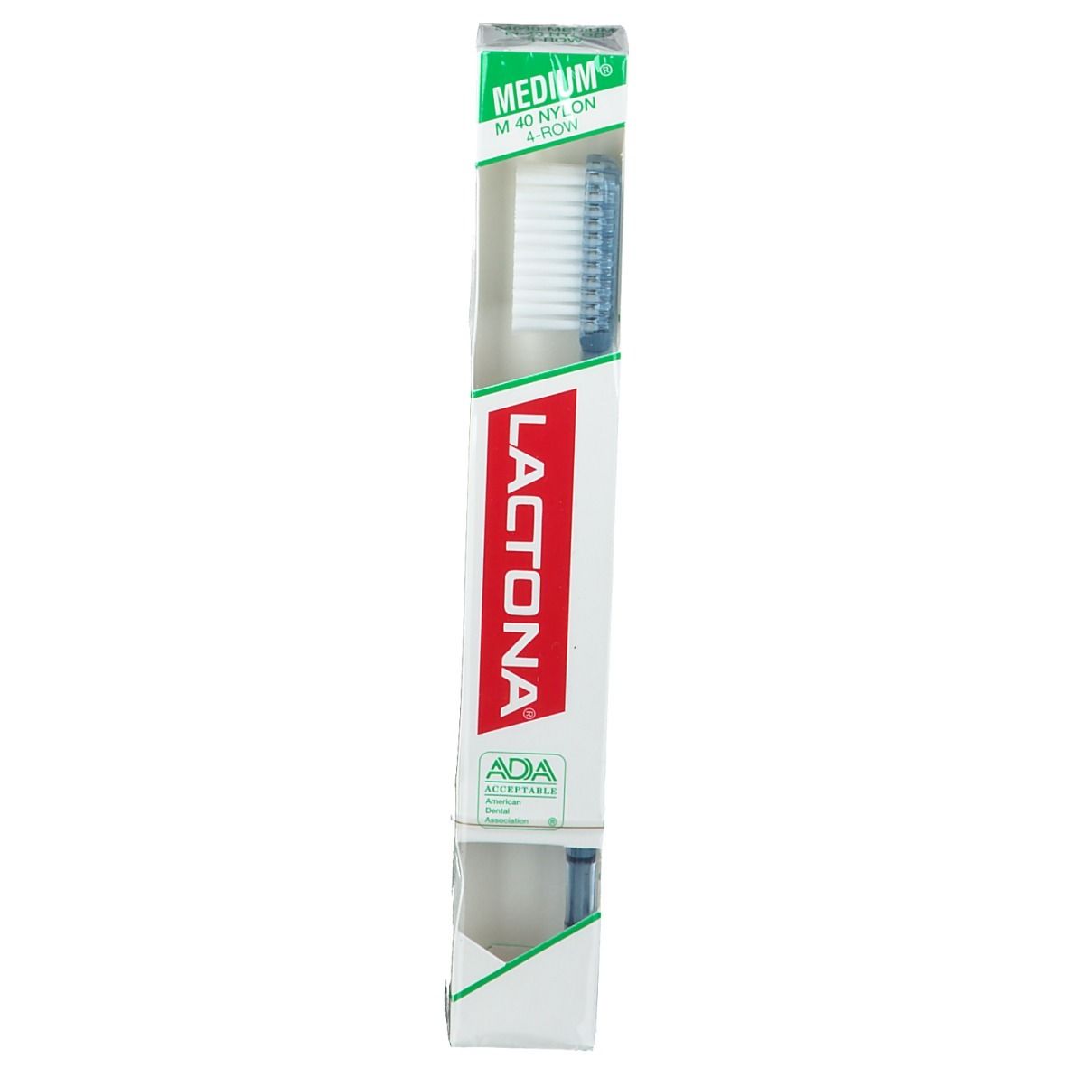 Brosse à dents dans son emballage. Marque Lactona, logo rouge. Emballage avec accent vert. Sceau ADA.