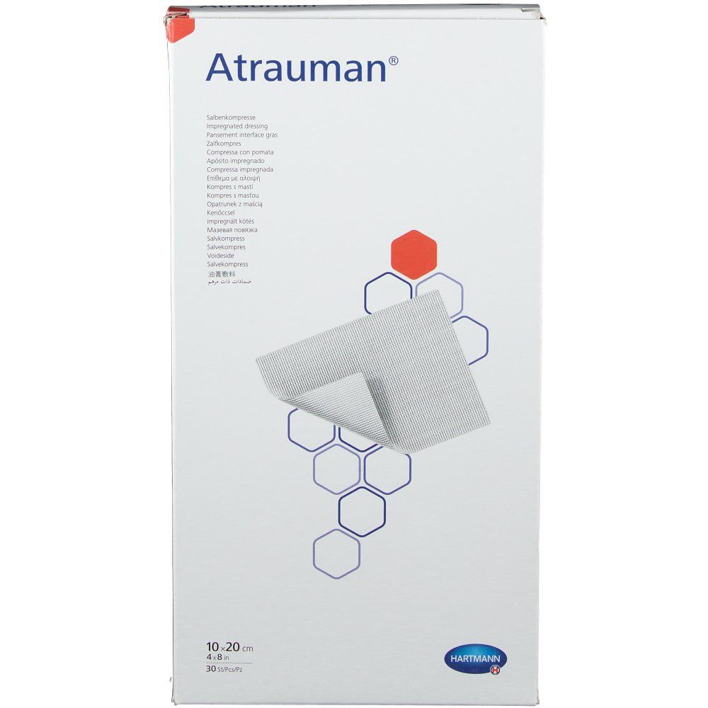 Emballage Atrauman. Boîte blanche avec nom et dimensions du produit. Compresse ouverte visible.