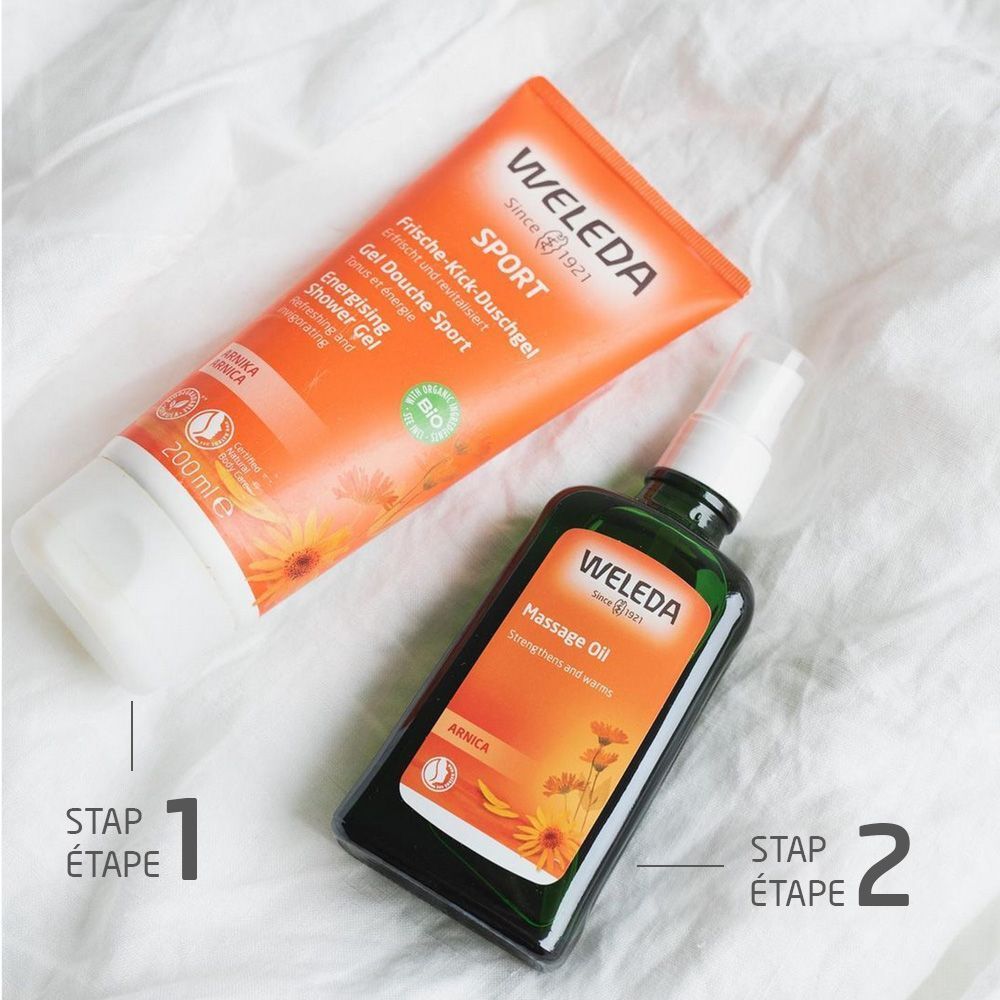 Deux produits sur tissu blanc. Gel douche Sport Weleda et huile de massage. Inscriptions avec noms de produits et marque.