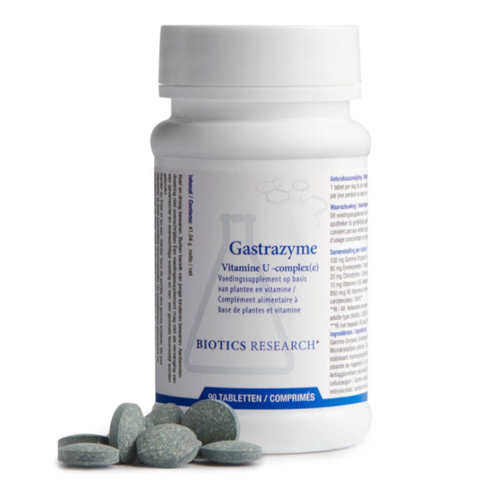 Flacon blanc 'Gastrazyme' avec comprimés à côté. Les comprimés sont gris-vert et ronds. 'Biotics Research' visible.