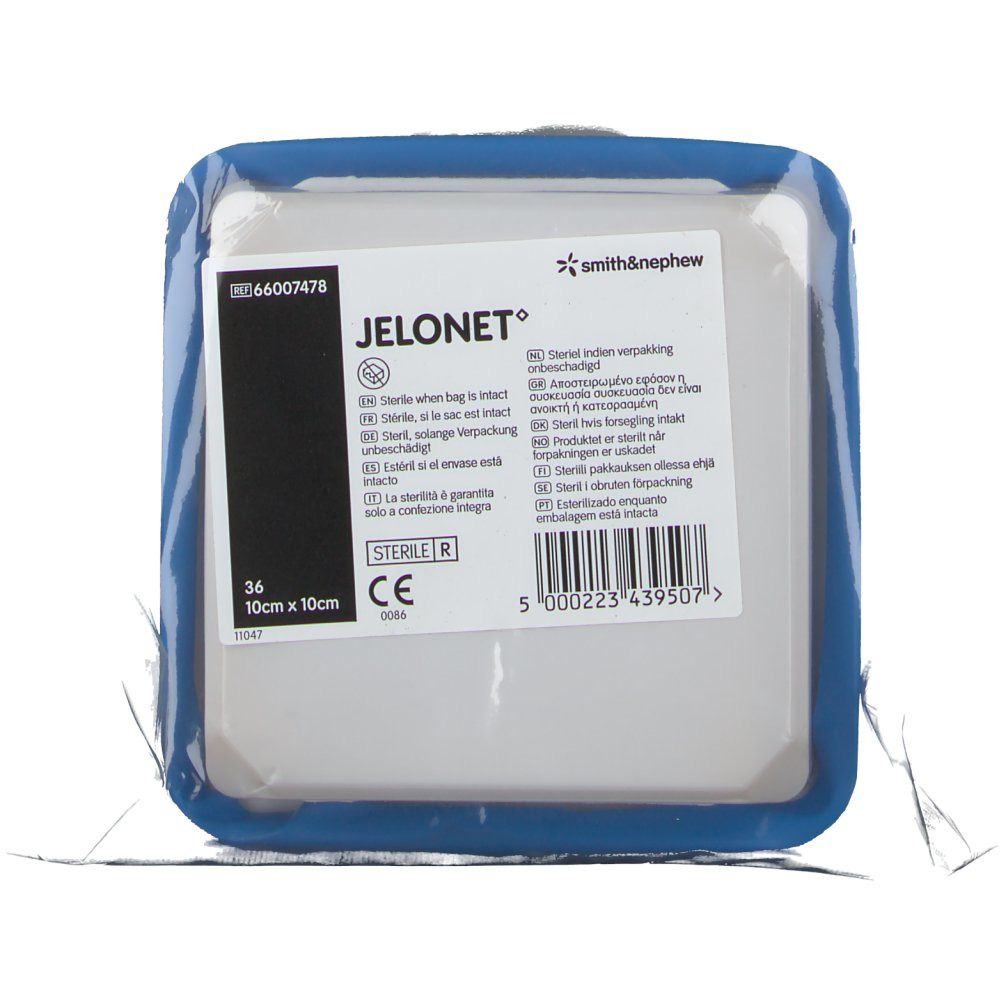 Compresse de gaze JELONET emballée. Forme carrée, bordure bleue. Texte : 10 cm x 10 cm, logo Smith & Nephew.