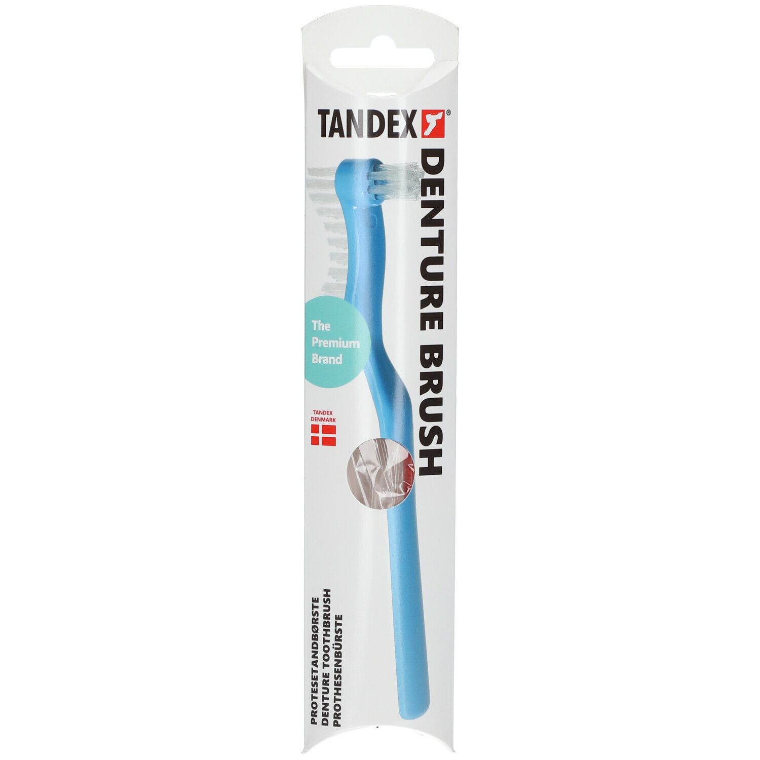Brosse à prothèse dentaire dans un emballage. Manche bleu clair, tête de brosse blanche. Marque Tandex.