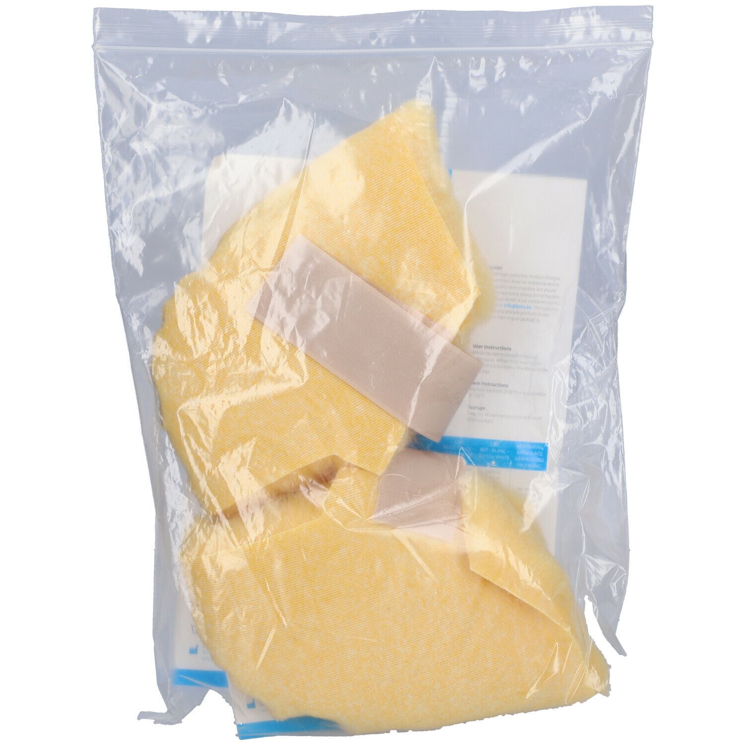Deux coussinets de talon beiges dans un emballage plastique. Fermetures velcro visibles. Produit emballé.