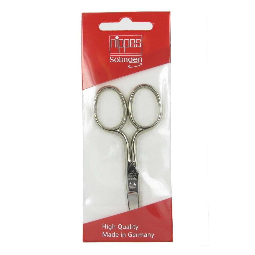 Ciseaux à ongles dans un emballage rouge. Marque 'Nippes Solingen'. Film transparent. Inscription 'High Quality Made in Germany'.