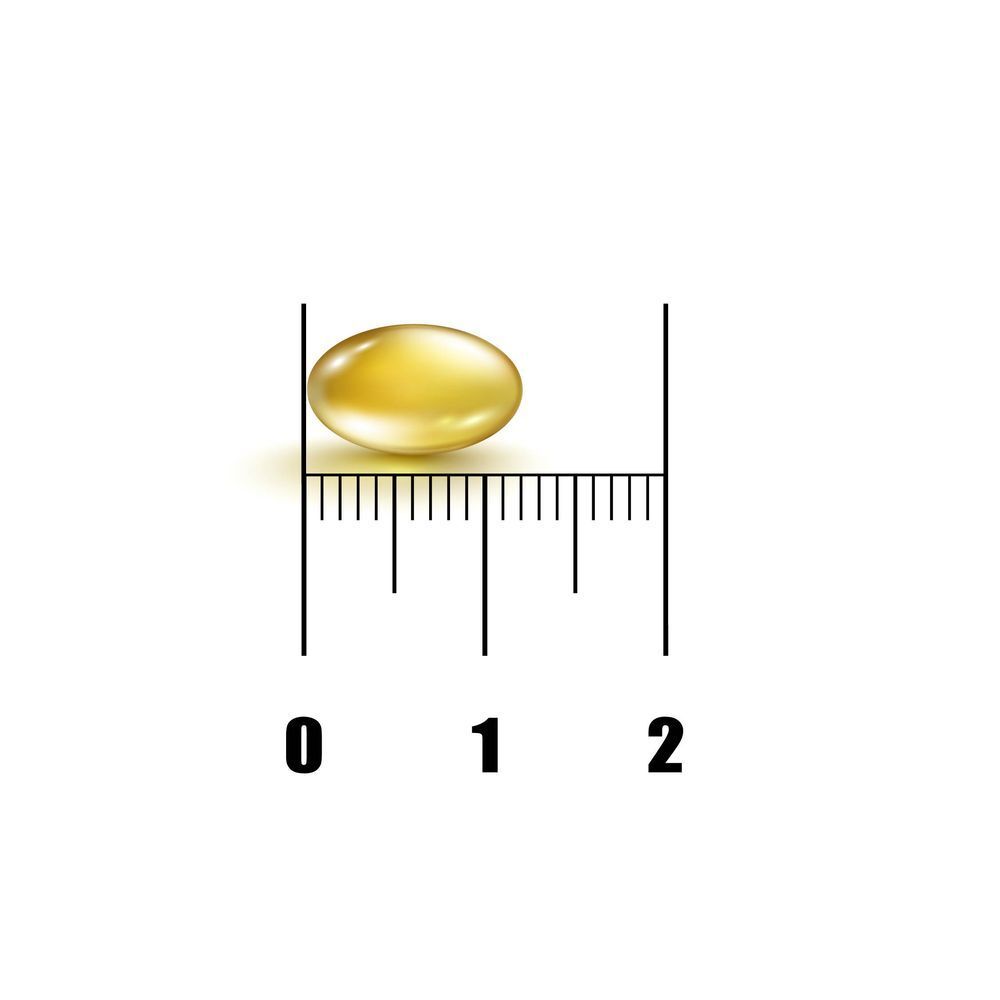 Gélule jaune sur fond blanc. Avec une échelle pour l'estimation de la taille. Gélule jaune.