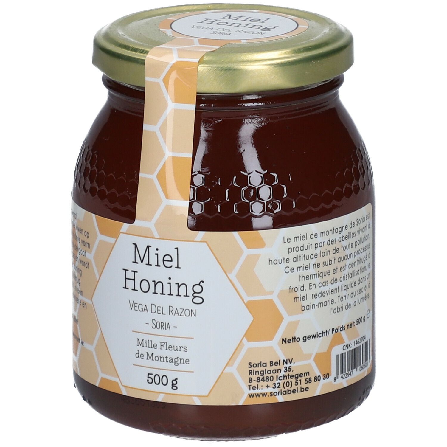 Glazen pot honing met gouden deksel. Etiket met productnaam, merk en gewicht. Honing donkerbruin.