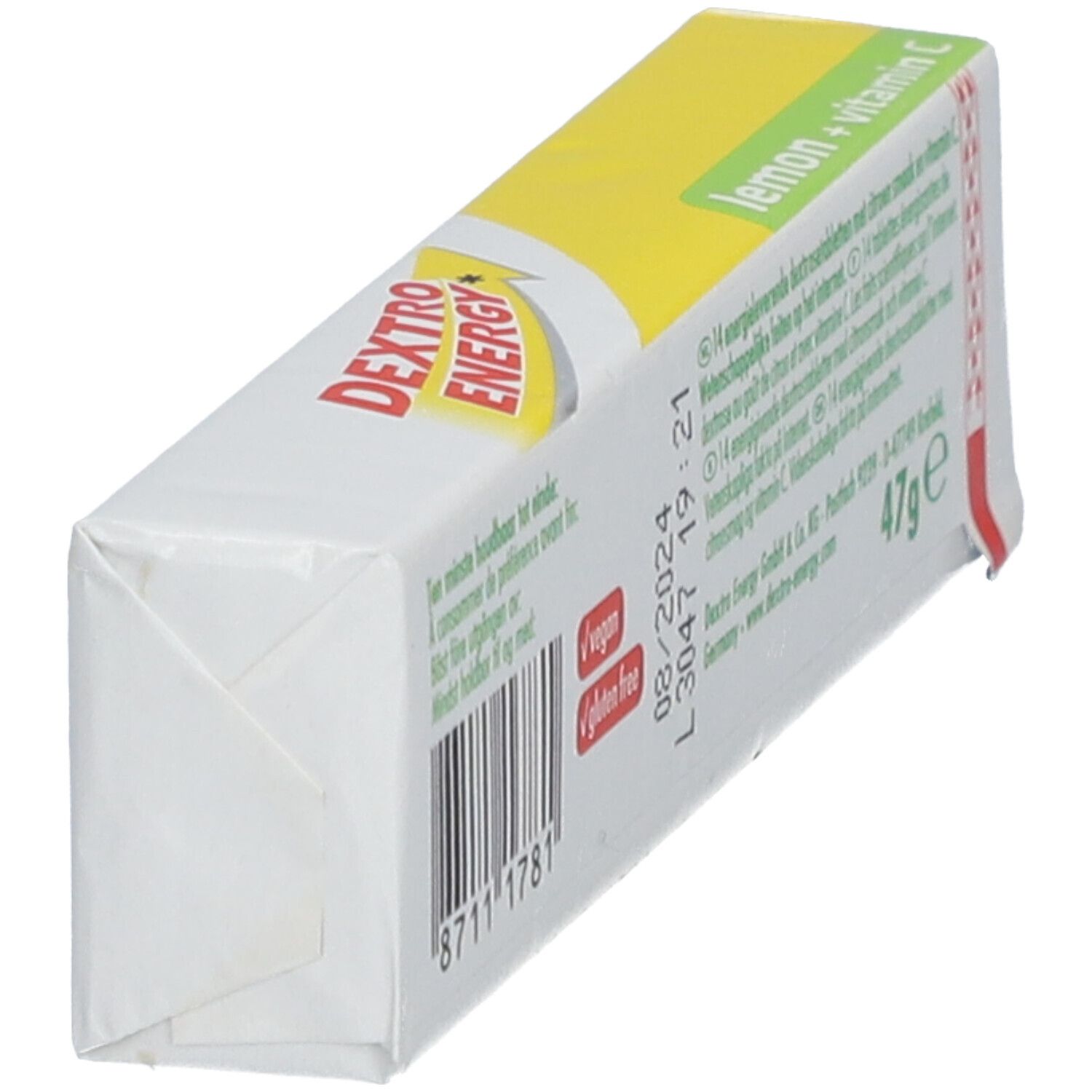 Vue oblique du dos de l'emballage Dextro Energy Zitrone + Vitamin C. Texte, code-barres, date de péremption.