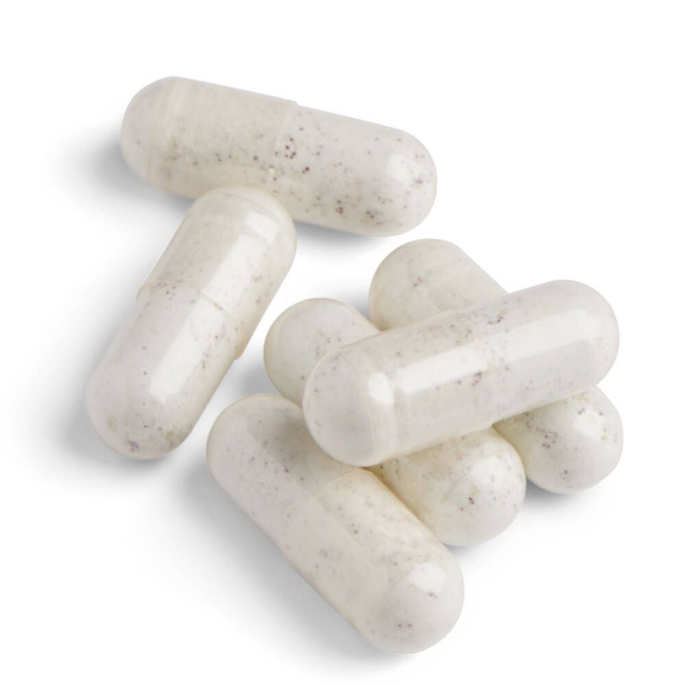 Plusieurs capsules blanches. Les capsules sont oblongues, lisses et de couleur claire.