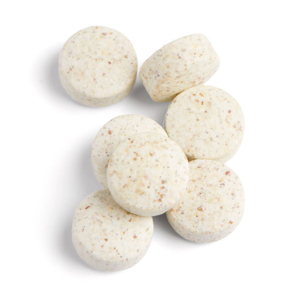 Sieben runde, beige Tabletten. Oberansicht. Ergänzungsmittel.