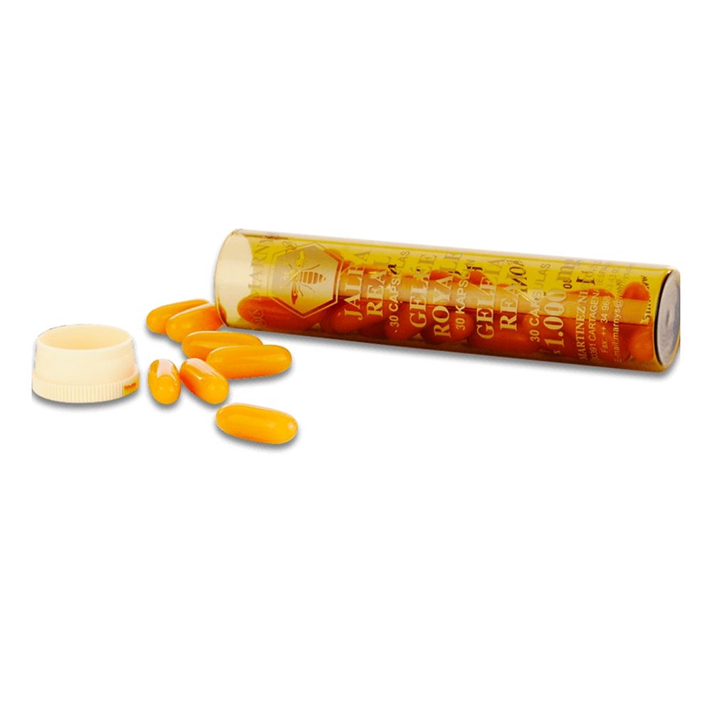 Capsules et emballage. Capsules jaunes à côté d'un emballage cylindrique ouvert.