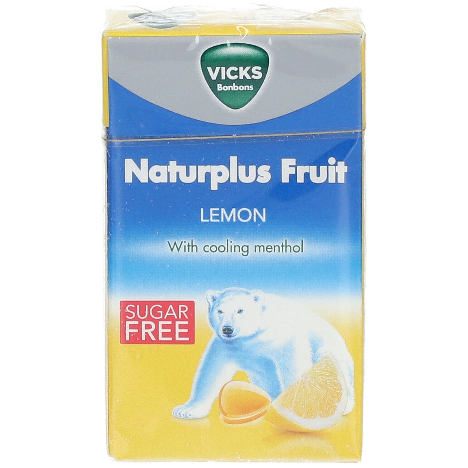 Face avant de la boîte jaune Vicks Naturplus Fruit. Inscription: Citron, sans sucre, ours polaire. En film.