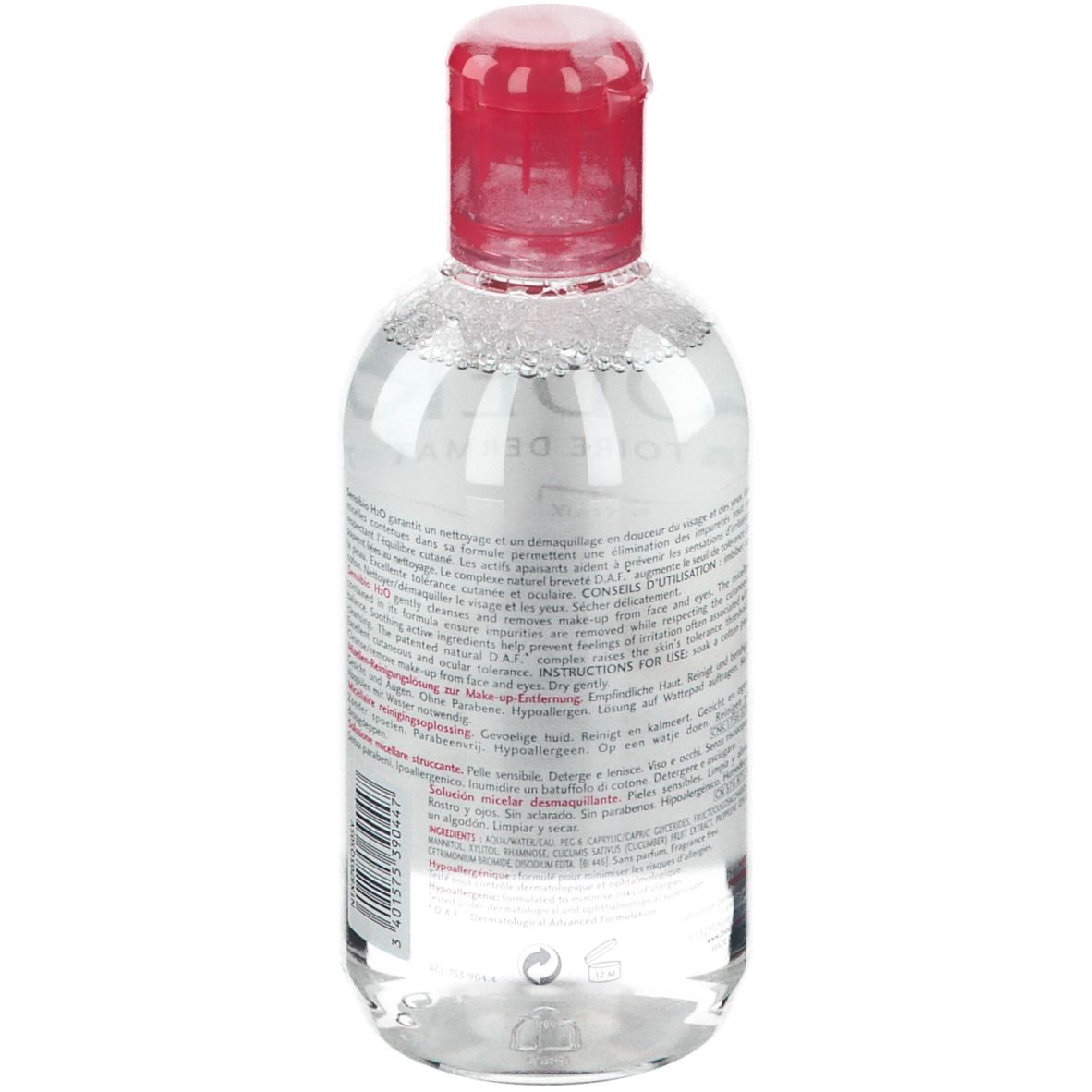 Rückseite einer transparenten Flasche mit rotem Verschluss. Text in mehreren Sprachen.