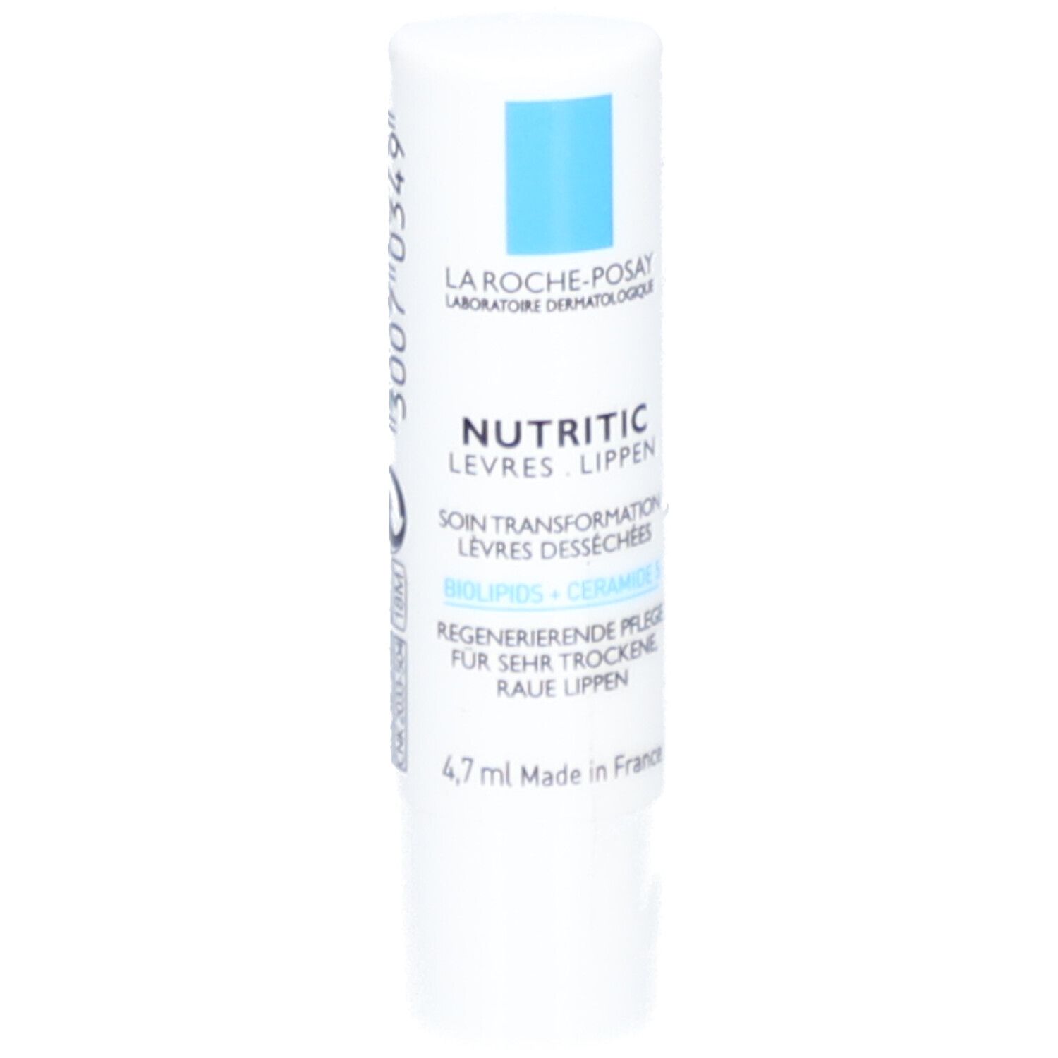 Stick à lèvres blanc avec texte bleu. Inscription: Nutritic Levres Lippen, Soin Transformation Levres Desséchées, 4,7 ml.
