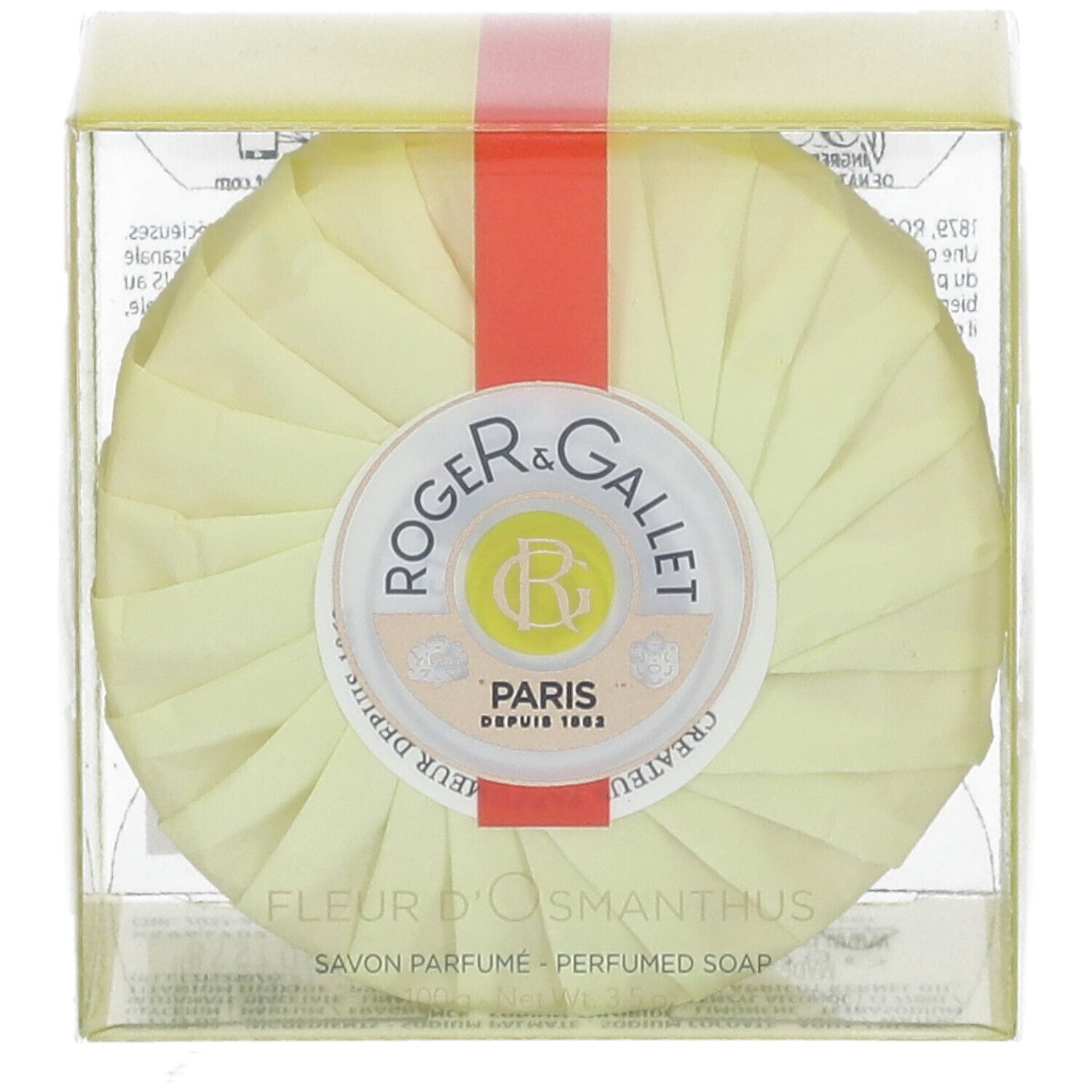 Savon rond emballé en jaune. Ruban rouge. Logo Roger & Gallet. Texte: Fleur d'Osmanthus, Savon Parfume.