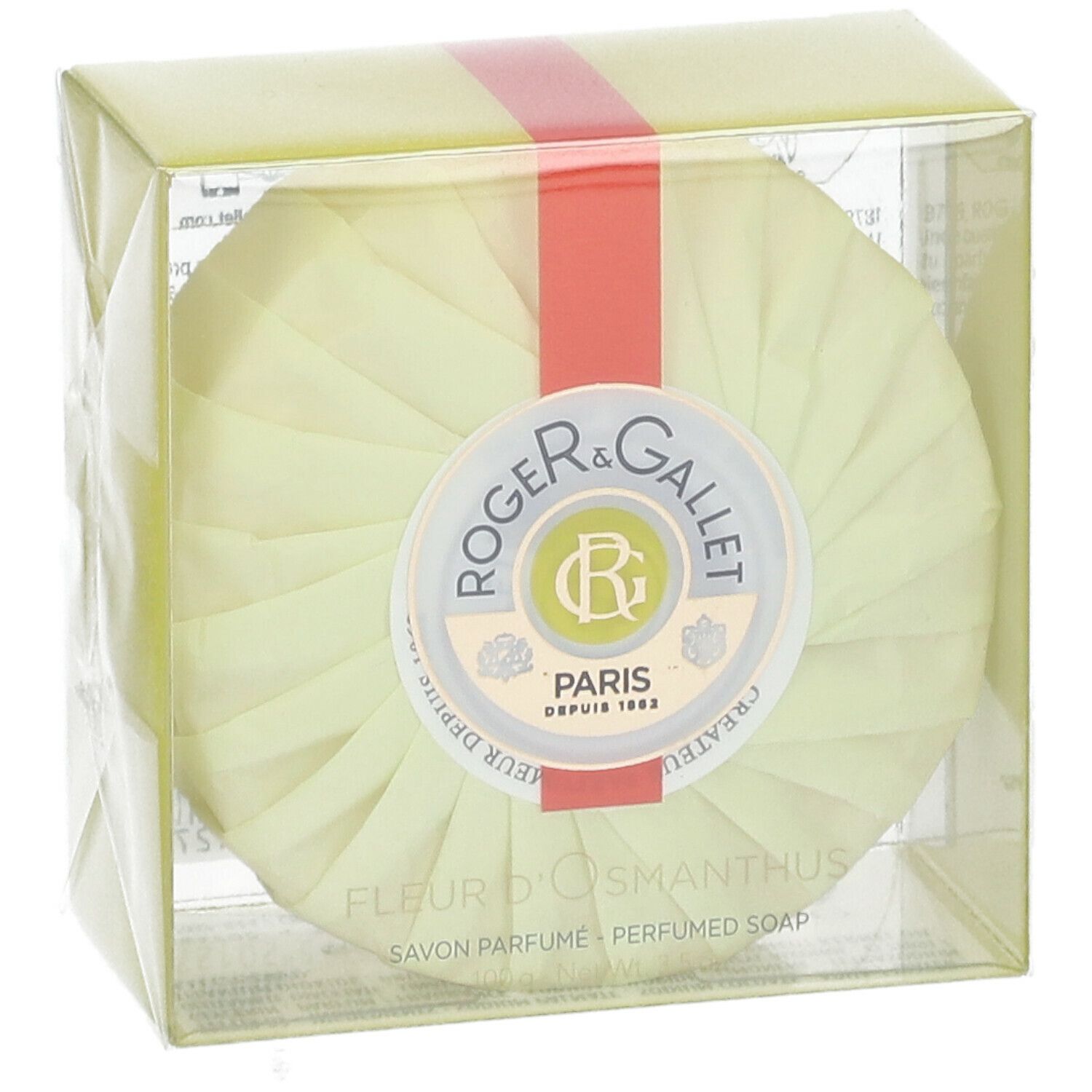 Savon rond emballé en jaune. Ruban rouge. Logo Roger & Gallet. Texte: Fleur d'Osmanthus, Savon Parfume.