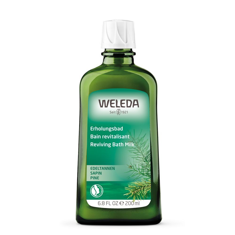 Flacon en verre vert avec bouchon blanc. Étiquette avec nom du produit, logo et informations. Inscription "Weleda".