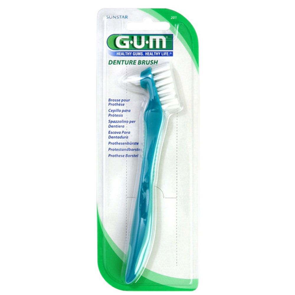 Brosse à prothèse dentaire bleu-turquoise, emballage blister. Logo GUM et nom du produit "Denture Brush" visibles.