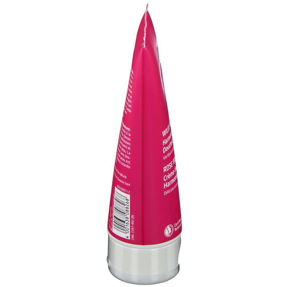 Vue latérale du tube. Tube rose avec bouchon blanc. Texte et code-barres visibles. Nom du produit et logo partiellement reconnaissables.