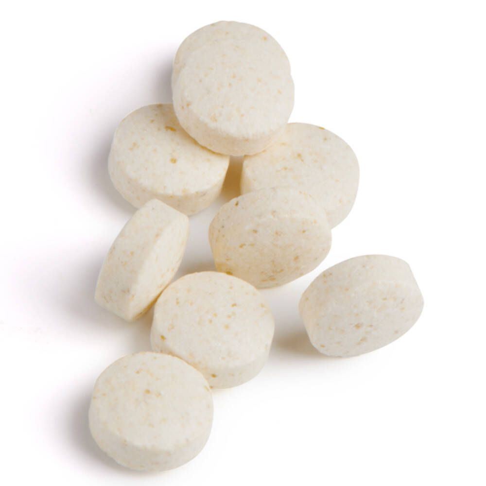 Acht runde, beige Tabletten. Keine Verpackung sichtbar.