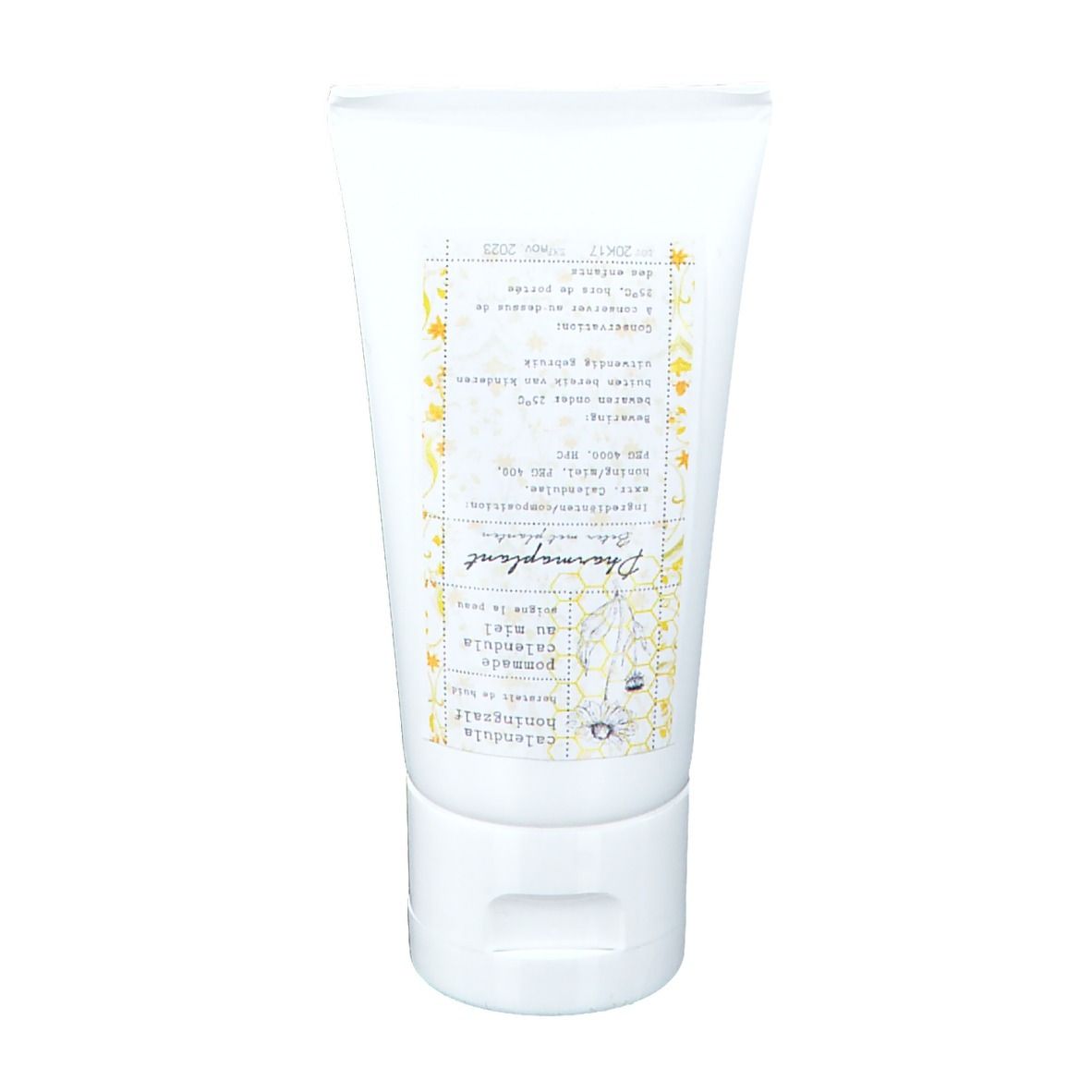 Witte tube met opdruk. Opschrift: Pharmaplant Calendula Honig Salbe. Gele bloemenachtergrond.