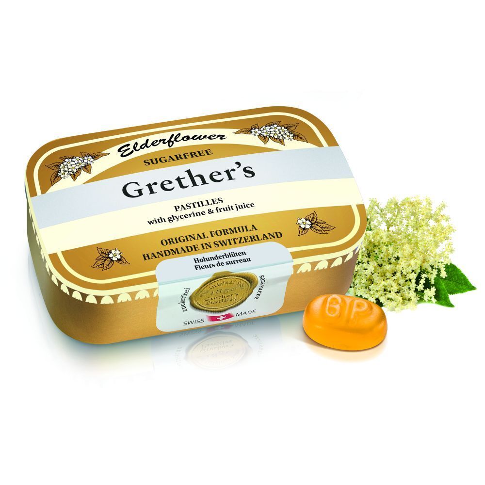 Boîte dorée de pastilles Grether's et une pastille. Inscription: Elderflower, Sugarfree, Original Formula.