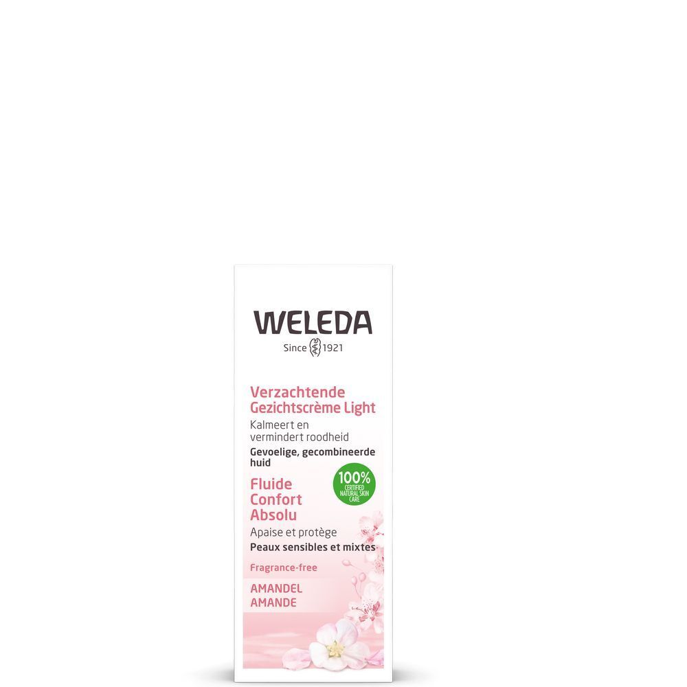 Weleda-Produktverpackung. Weiß, mit Text und Logo. "Fluide Confort Absolu" und "Amandel" sind lesbar. 100% Natural Skin Care-Siegel.