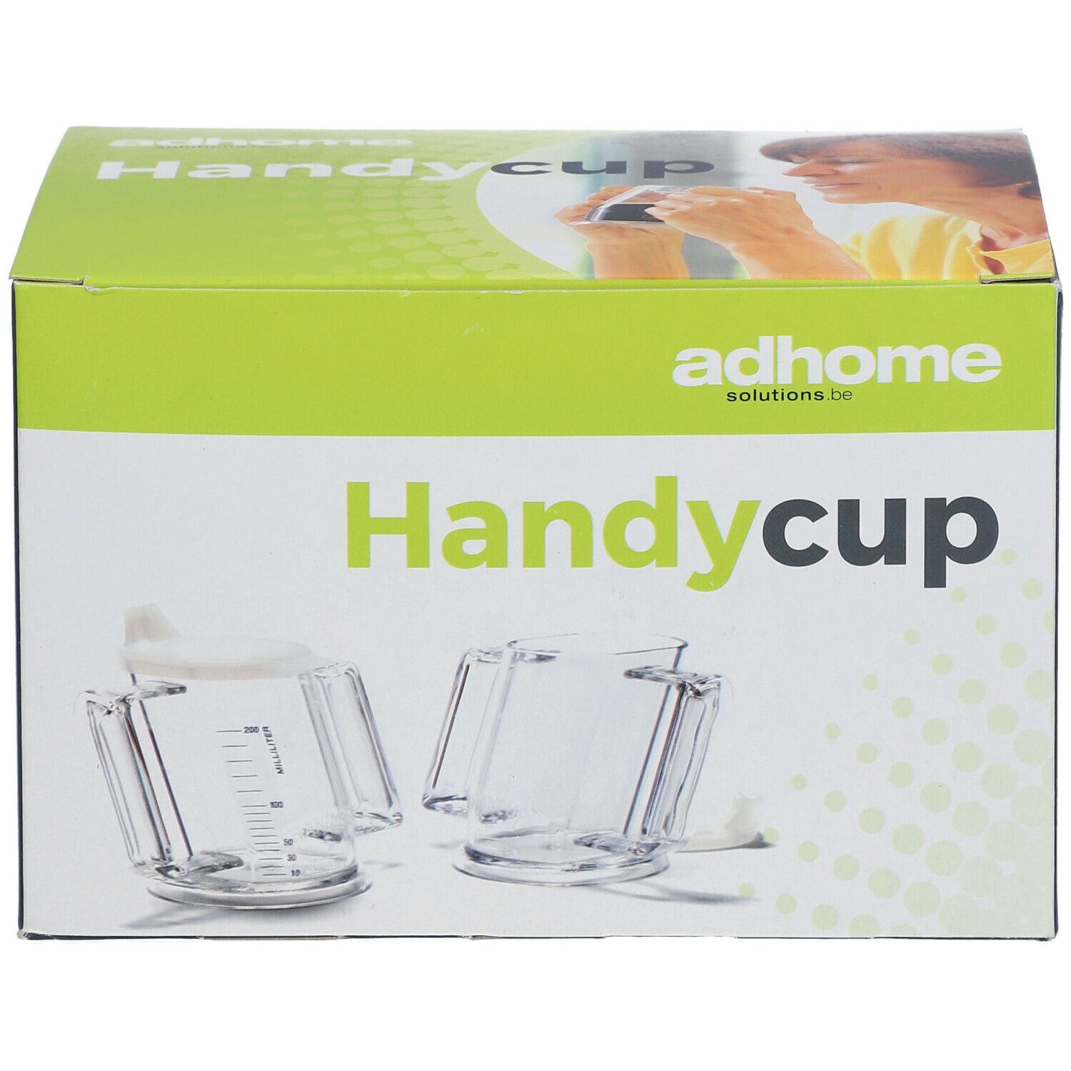 Verpakking van Handycup. Opschrift: Handycup, adhome solutions.be. Twee transparante bekers met deksels en handvatten afgebeeld.