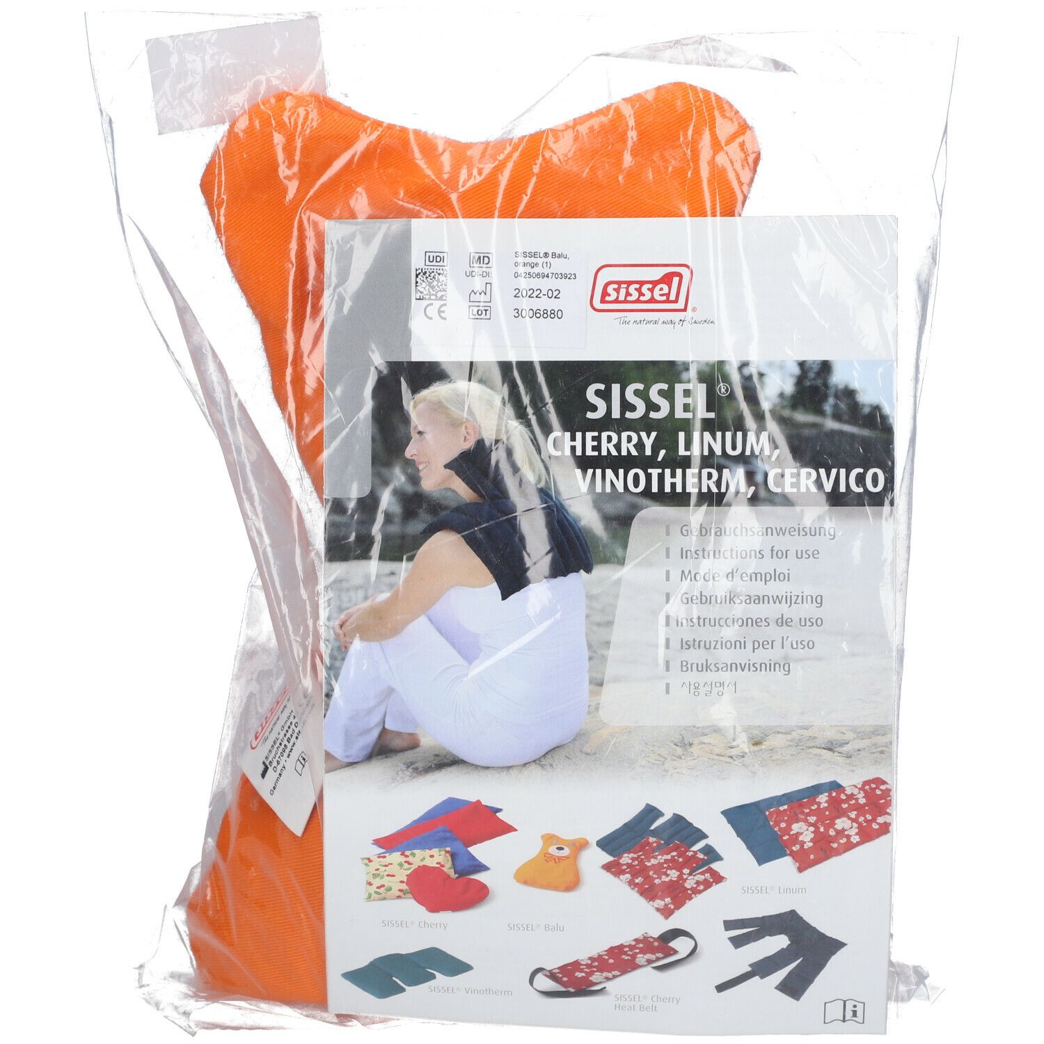 Coussin aux noyaux de cerises orange, emballé. Informations produit et accessoires visibles.
