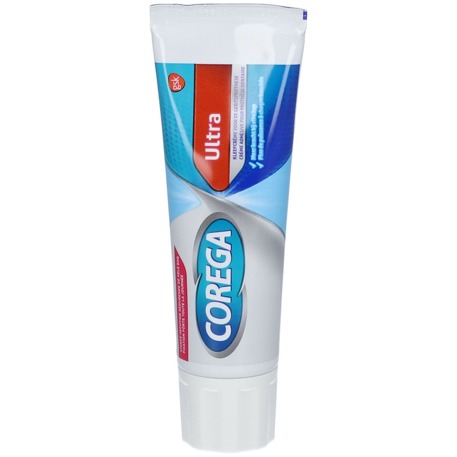 Zahncreme-Tube mit rotem und blauem Design. Aufschrift "Ultra" und "Corega". Weiße Kappe.