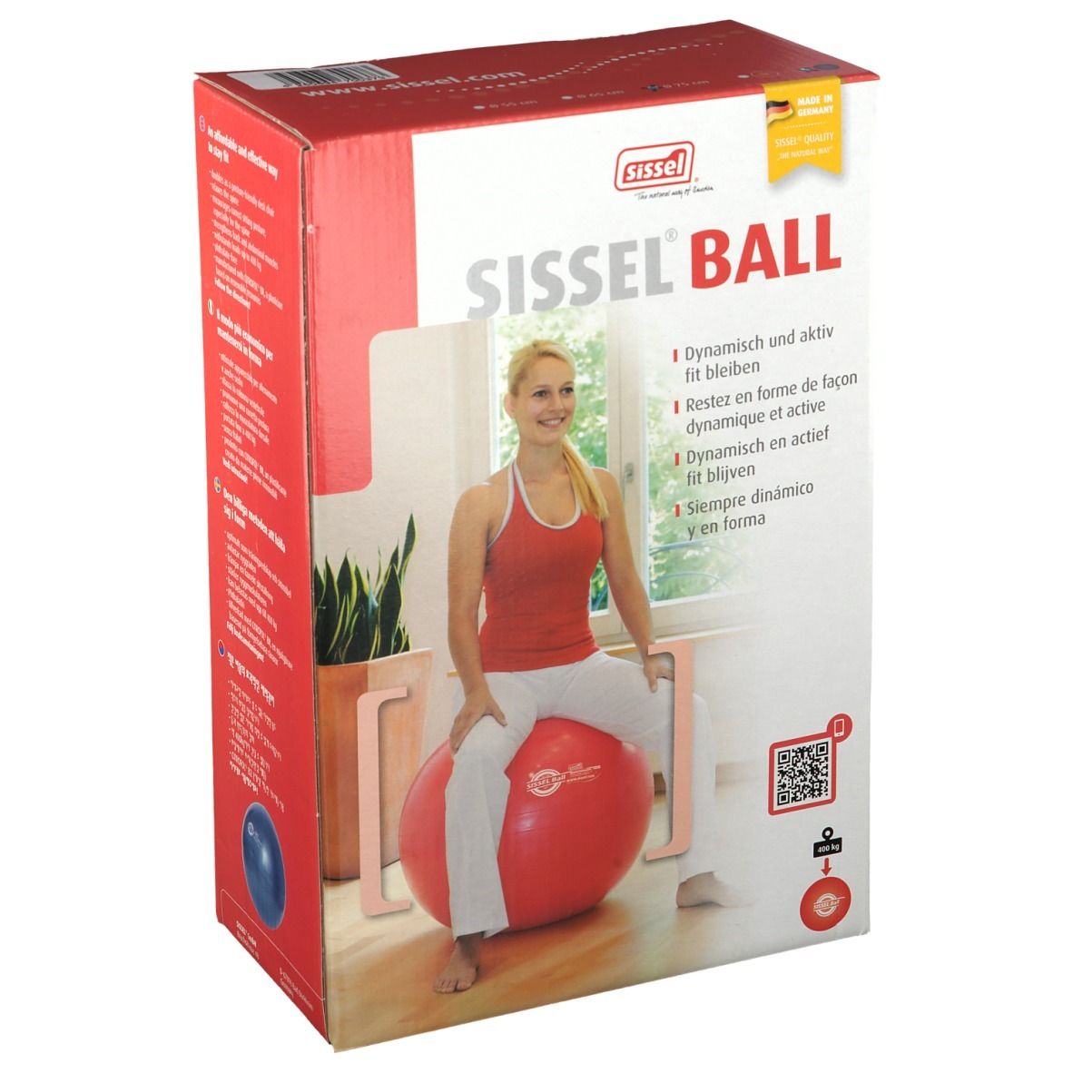 Boîte Sissel Ball rouge. Femme assise sur le ballon. Inscription: Sissel Ball.